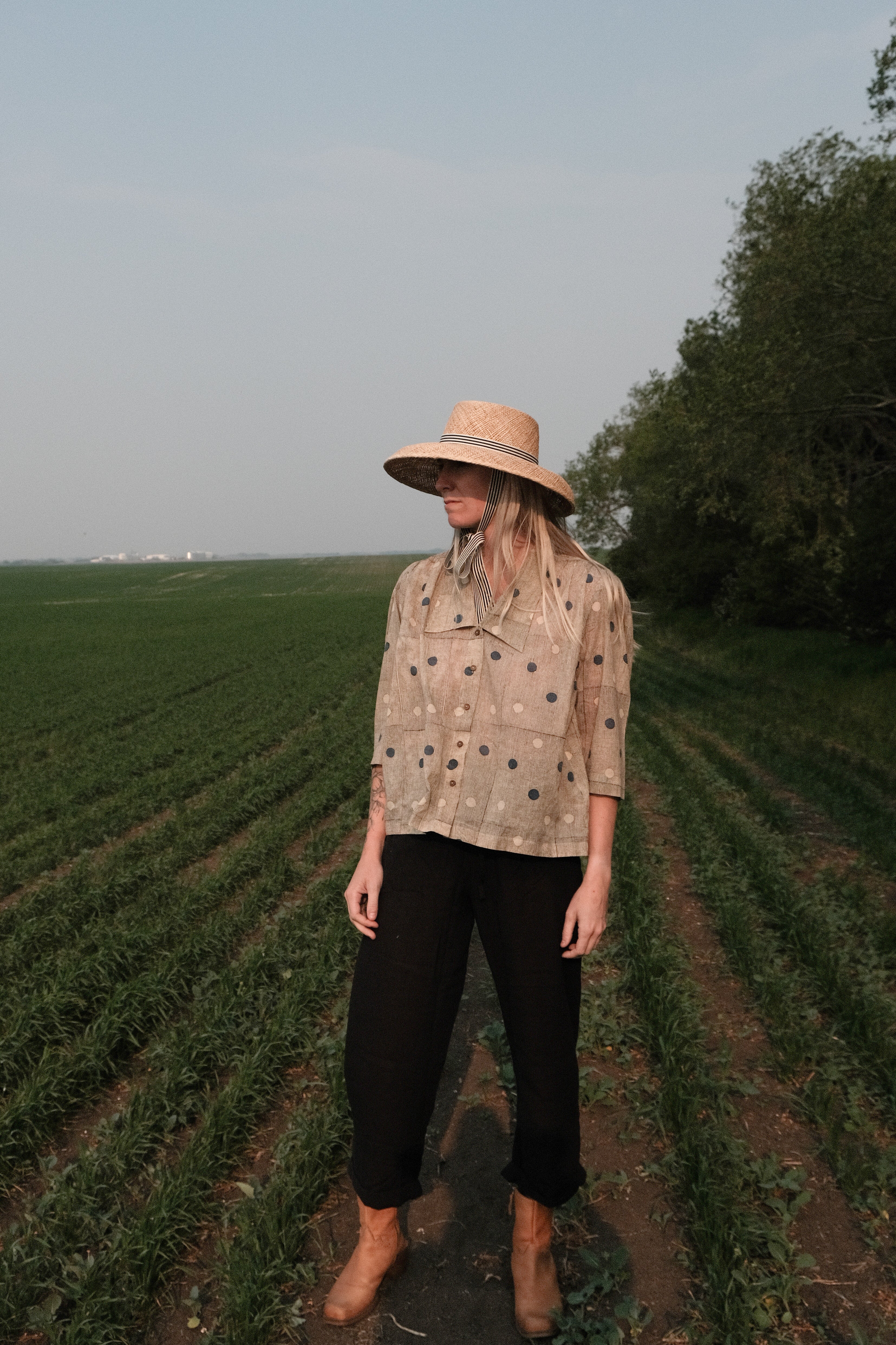 Black and tan hand block-printed top made from 100% organic cotton, featuring a front button opening and a relaxed silhouette. Naturally dyed and ethically crafted, the lightweight, non-stretchy fabric feels soft and breathable against the skin. Each piece is one-of-a-kind, with subtle variations in print and color that highlight its artisanal charm. Falls 25” from the shoulder and fits true to size—ideal for conscious, everyday wear.