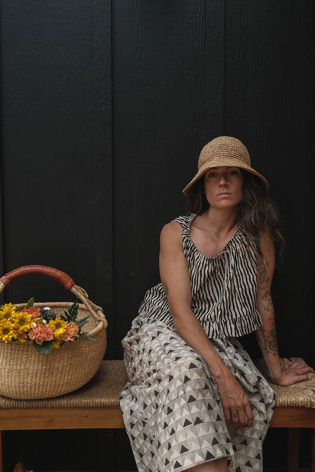 Alice's top is a quintessential top with black & white stripes. The hand-made top features a gathered scoop neckline with a tie detail. The fabric is soft and lightweight making this garment perfect for all day wear.