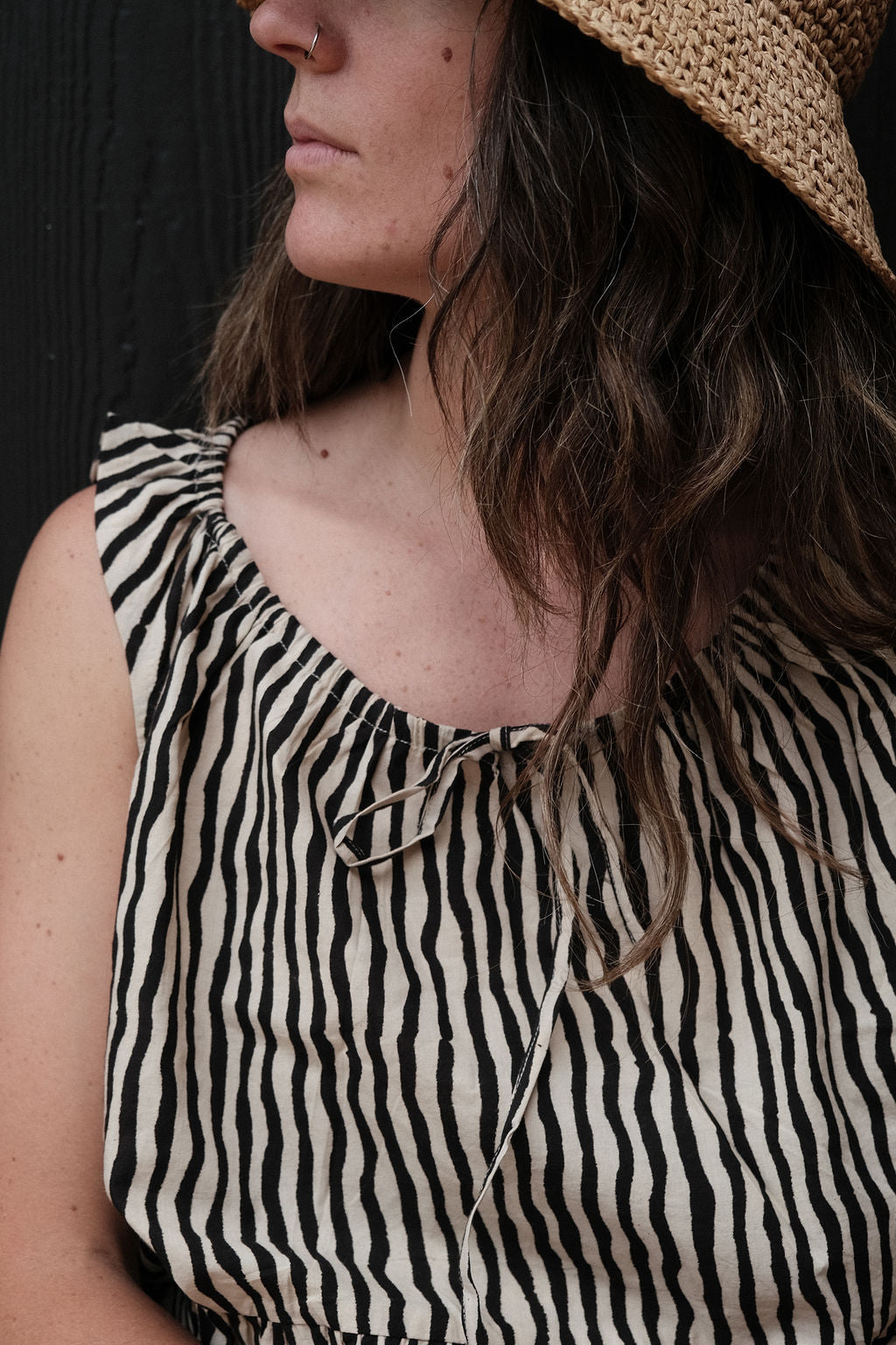 Alice's top is a quintessential top with black & white stripes. The hand-made top features a gathered scoop neckline with a tie detail. The fabric is soft and lightweight making this garment perfect for all day wear.