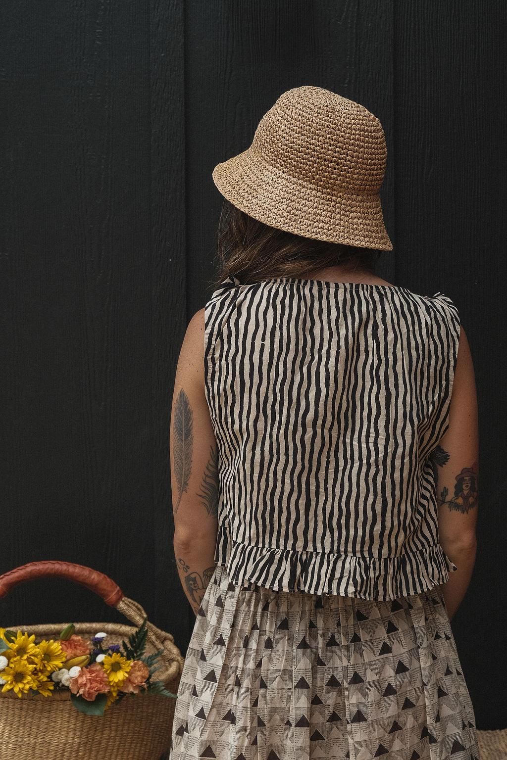 Alice's top is a quintessential top with black & white stripes. The hand-made top features a gathered scoop neckline with a tie detail. The fabric is soft and lightweight making this garment perfect for all day wear.