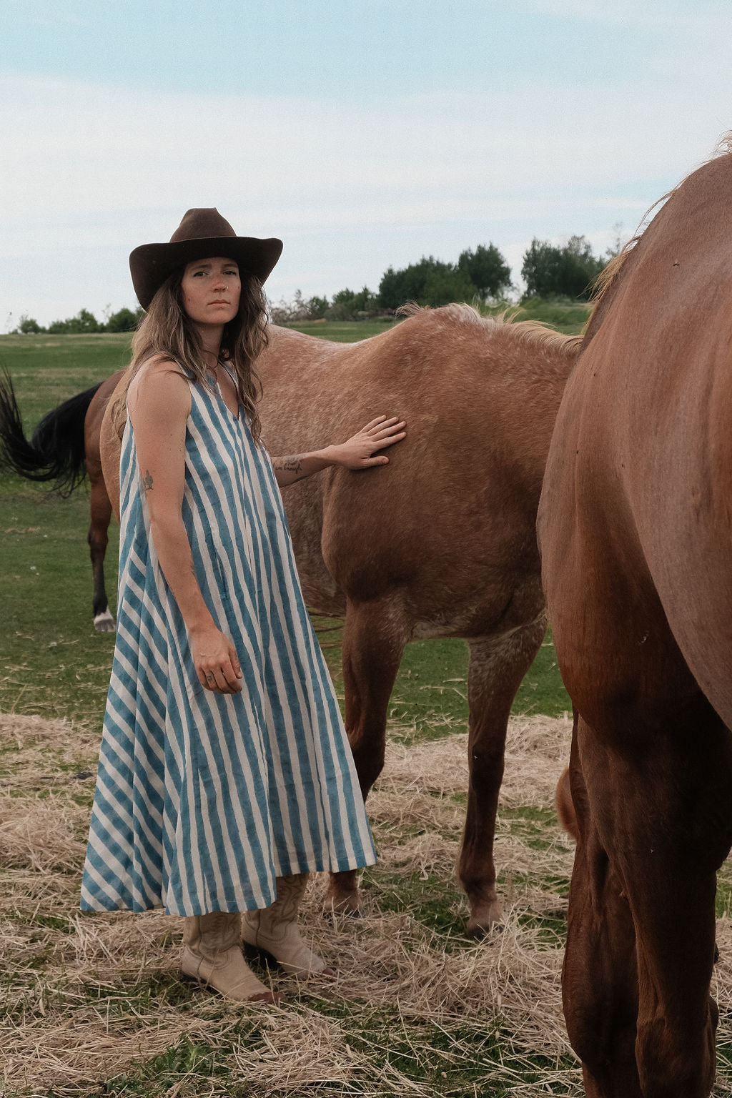Sleeveless blue & white striped, hand woven cotton dress. The A-line silhouette and midi length at the charm to the dress. It has a V-neck adding the feminine touch to the bespoke piece.