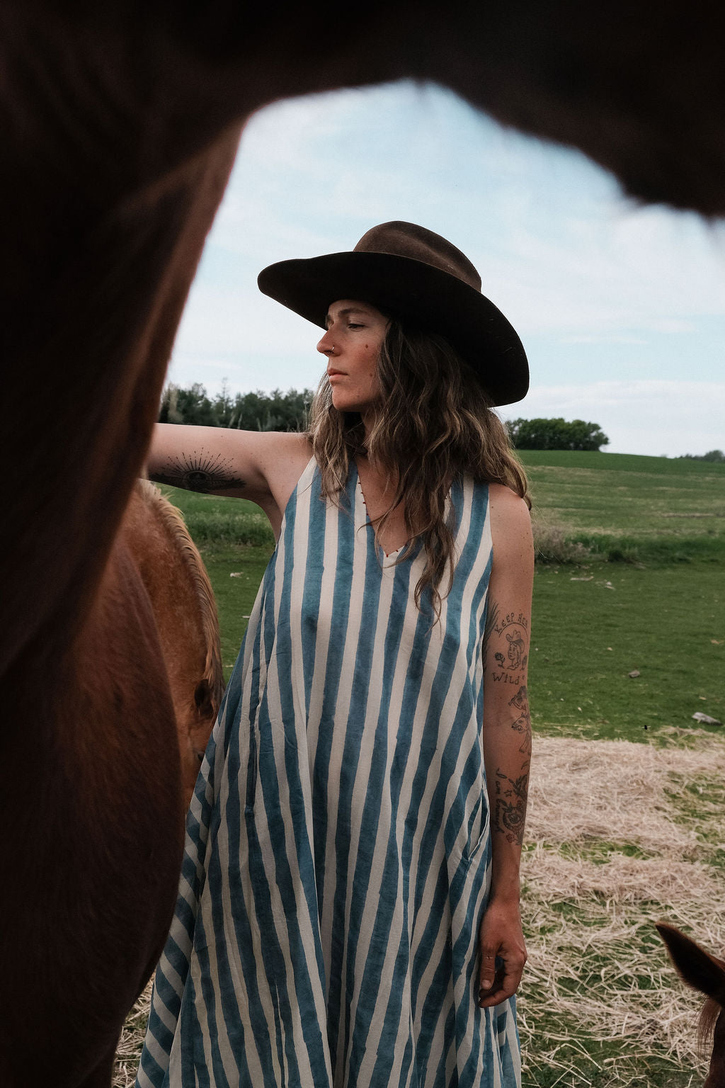 Sleeveless blue & white striped, hand woven cotton dress. The A-line silhouette and midi length at the charm to the dress. It has a V-neck adding the feminine touch to the bespoke piece.