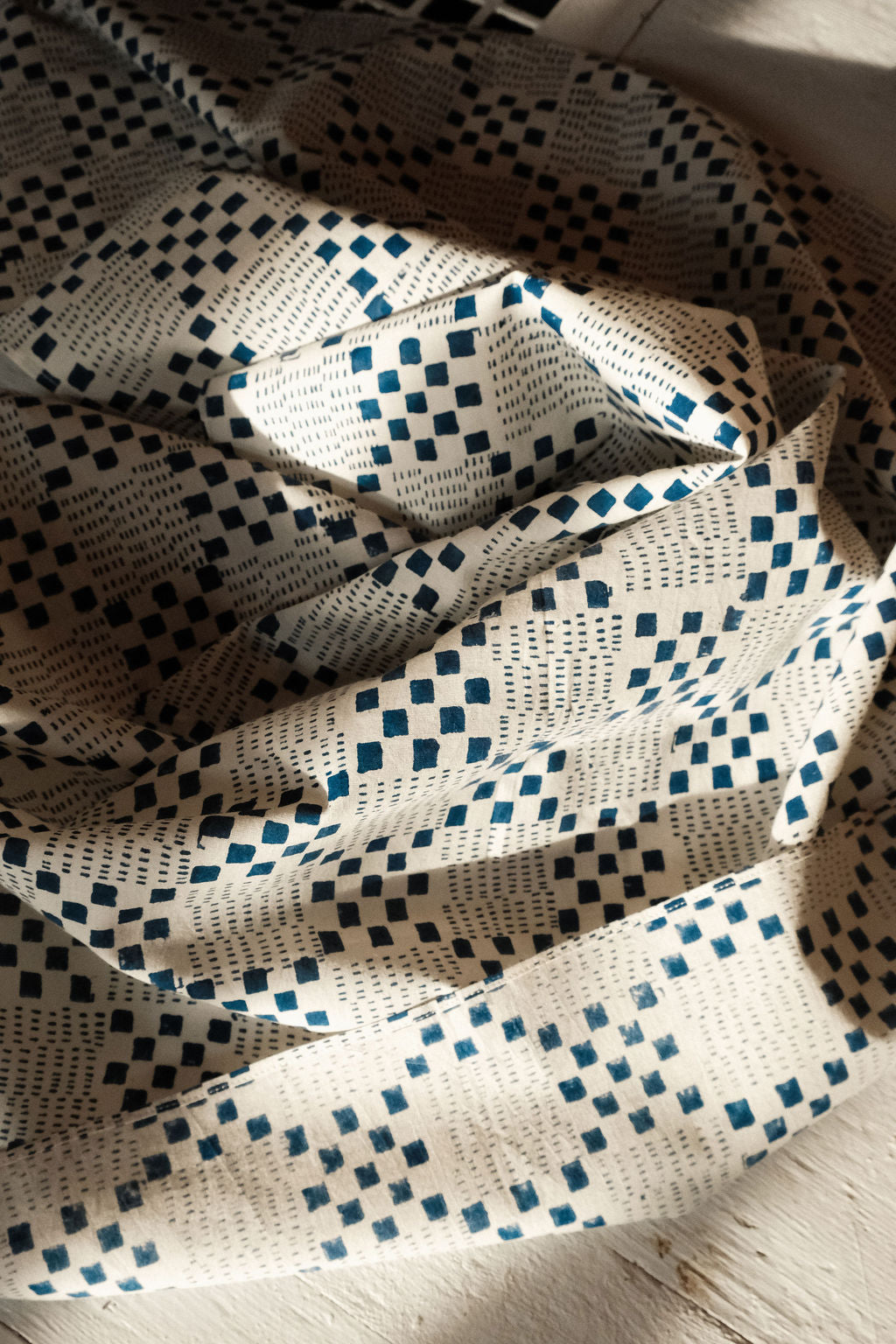 Navy blue and white handwoven checkered cotton bandana by World of Crow, ethically made in India using traditional weaving techniques – sustainable slow fashion accessory for versatile styling.