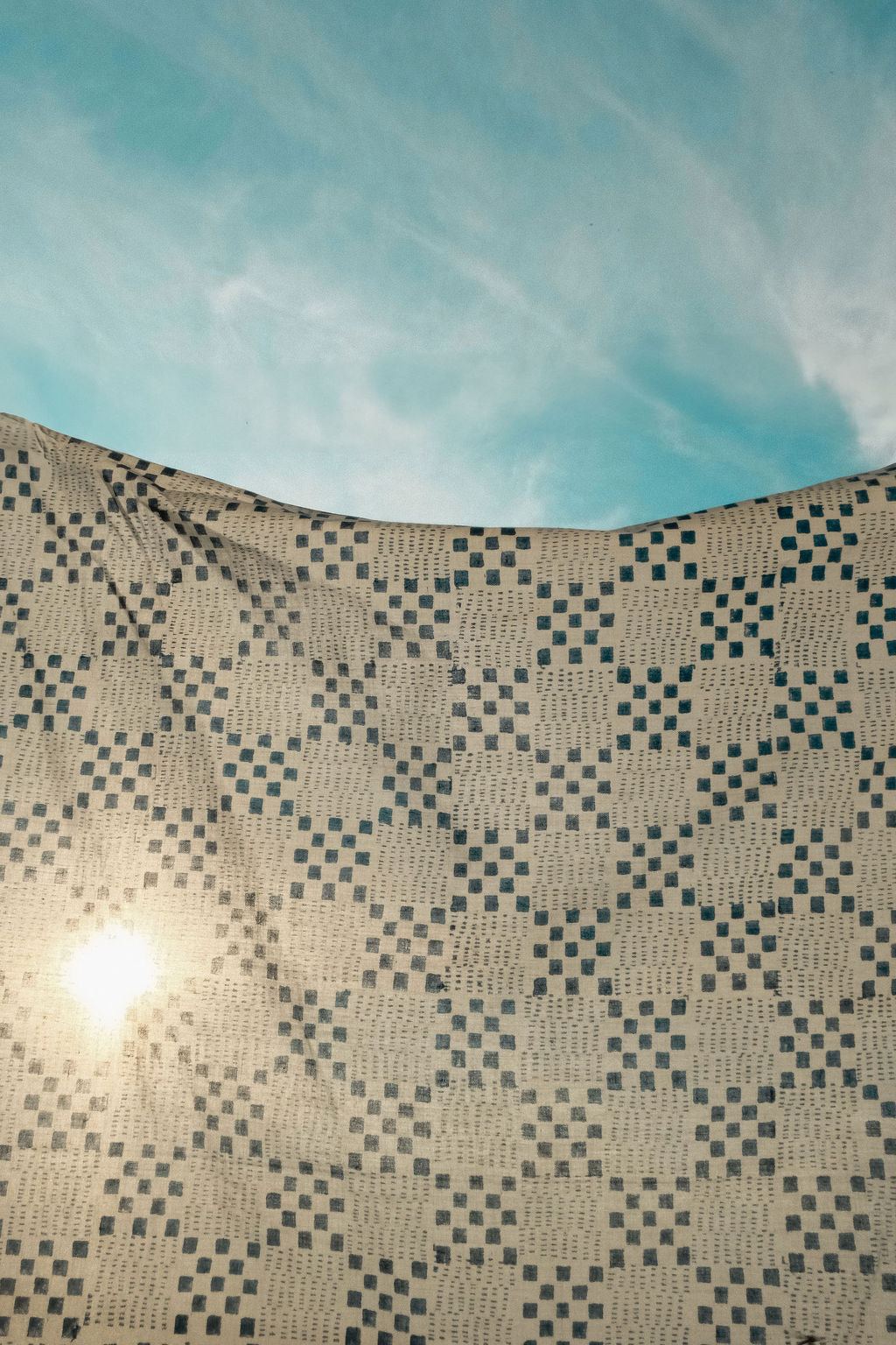 Navy blue and white handwoven checkered cotton bandana by World of Crow, ethically made in India using traditional weaving techniques – sustainable slow fashion accessory for versatile styling.