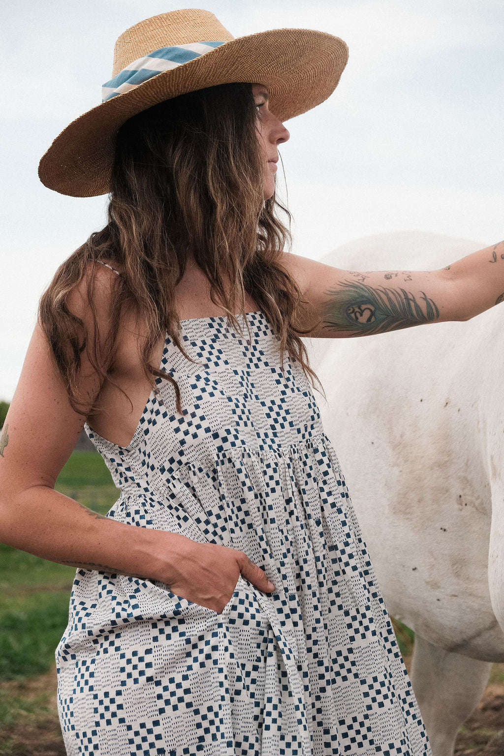 White and indigo blue hand block-printed dress made from 100% organic cotton, crafted with azo-free dyes for a soft and breathable feel. Ethically made with a lightweight, non-stretchy fabric, the dress falls 45” from the shoulder in size S and offers a true-to-size fit. Each garment is uniquely one-of-a-kind, with natural variations in color and pattern that highlight its handcrafted charm—perfect for conscious, everyday dressing.