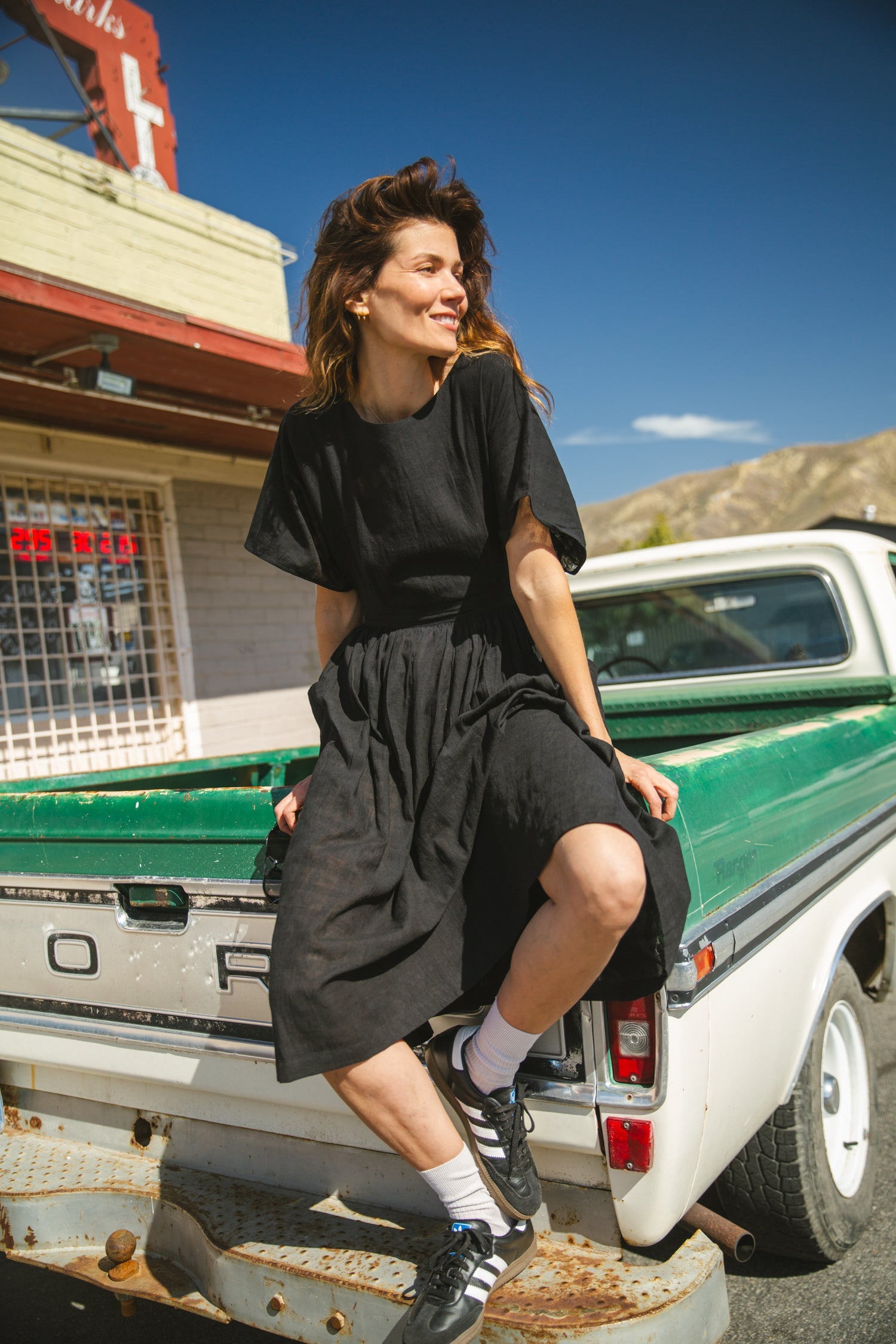 Black jamdani fabric dress with a soft, breathable texture, featuring a fitted bodice, cinched waist, and a flowy midi skirt for an effortlessly elegant and timeless silhouette.