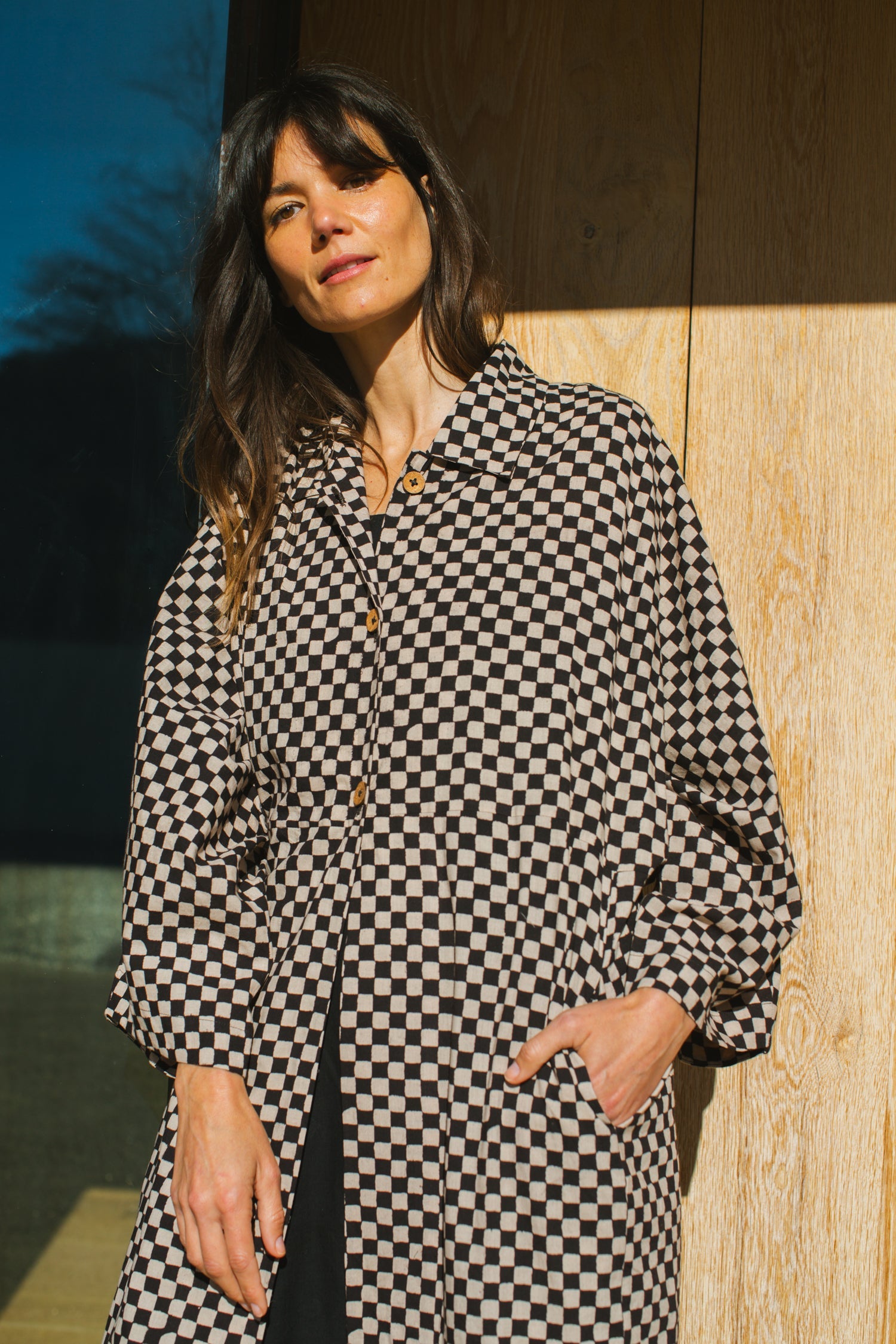 Elevate your style with this eye-catching red duster jacket, adorned with coconut buttons for a touch of natural charm. Crafted from high-quality block print fabric, this jacket boasts a timeless black and white checkered pattern, adding sophistication to any ensemble