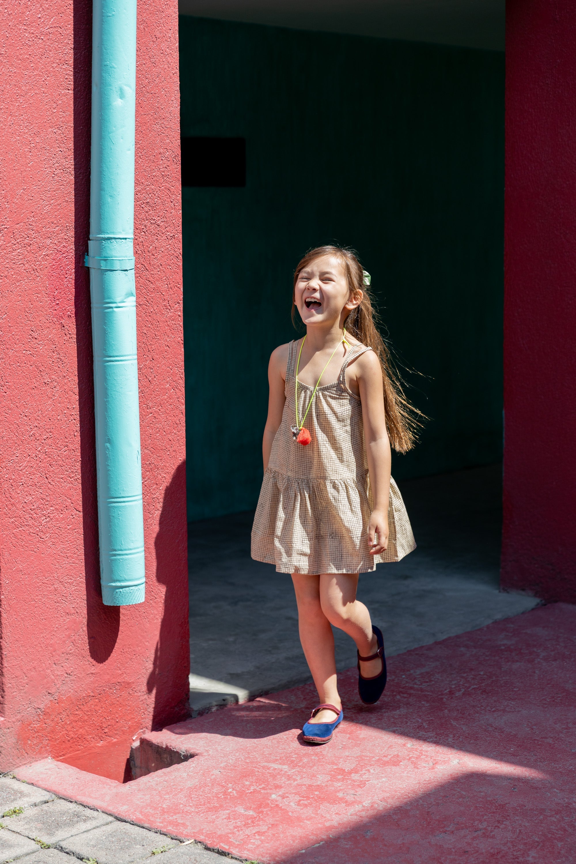 Honey-checked sleeveless frock with a ruched bodice, thin shoulder straps, and a tiered, flared skirt for a breezy, playful look.