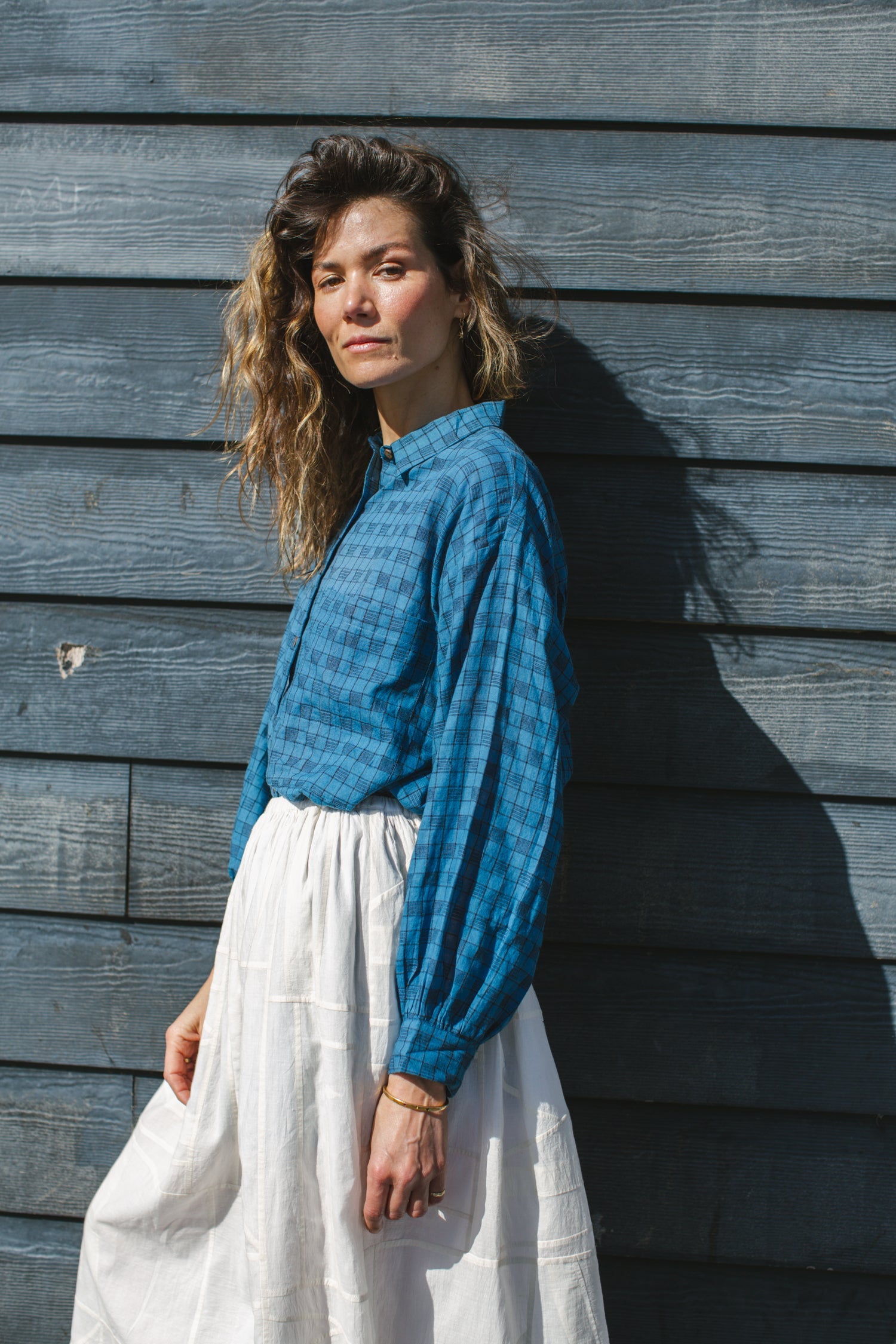 Blue long-sleeve button-down shirt with a subtle textured pattern. Features a classic pointed collar and a relaxed fit, perfect for effortless styling. Made from breathable fabric for all-day comfort. Ideal for casual and semi-formal looks.