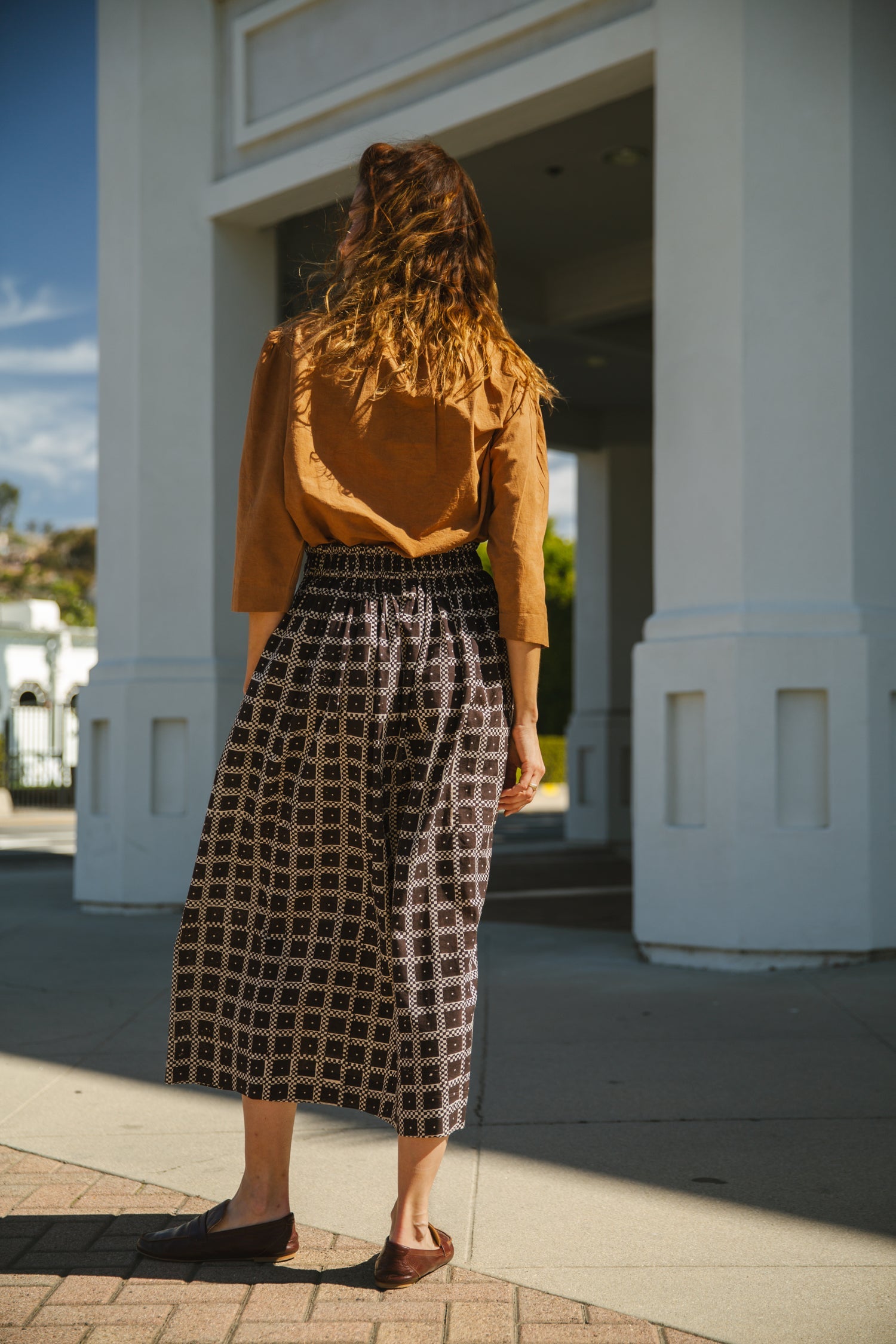 Black and white printed midi skirt with an elastic waistband, featuring a geometric pattern, flowy silhouette, and lightweight fabric for an effortlessly chic and comfortable style.