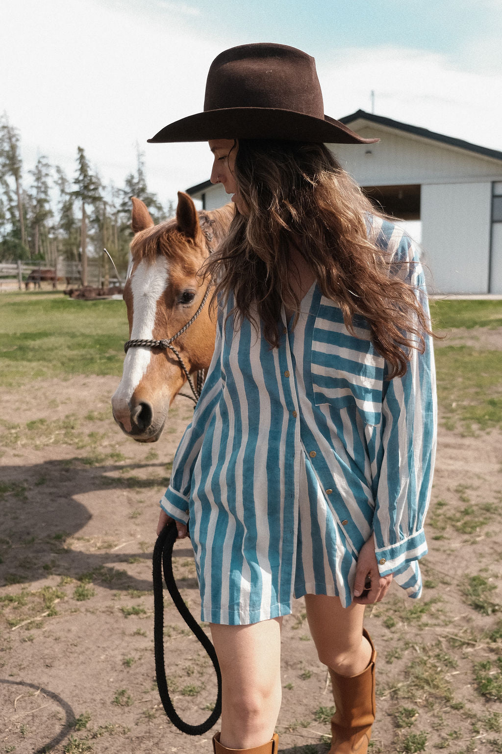 This summer blue artist smock  has vertical blue and white stripes, classic collar, and a chest pocket with contrasting horizontal stripes. Made with soft cotton fabric and natural color.