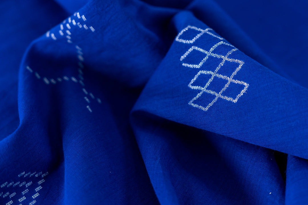 close up of our jamdani fabric with white geometrical motif