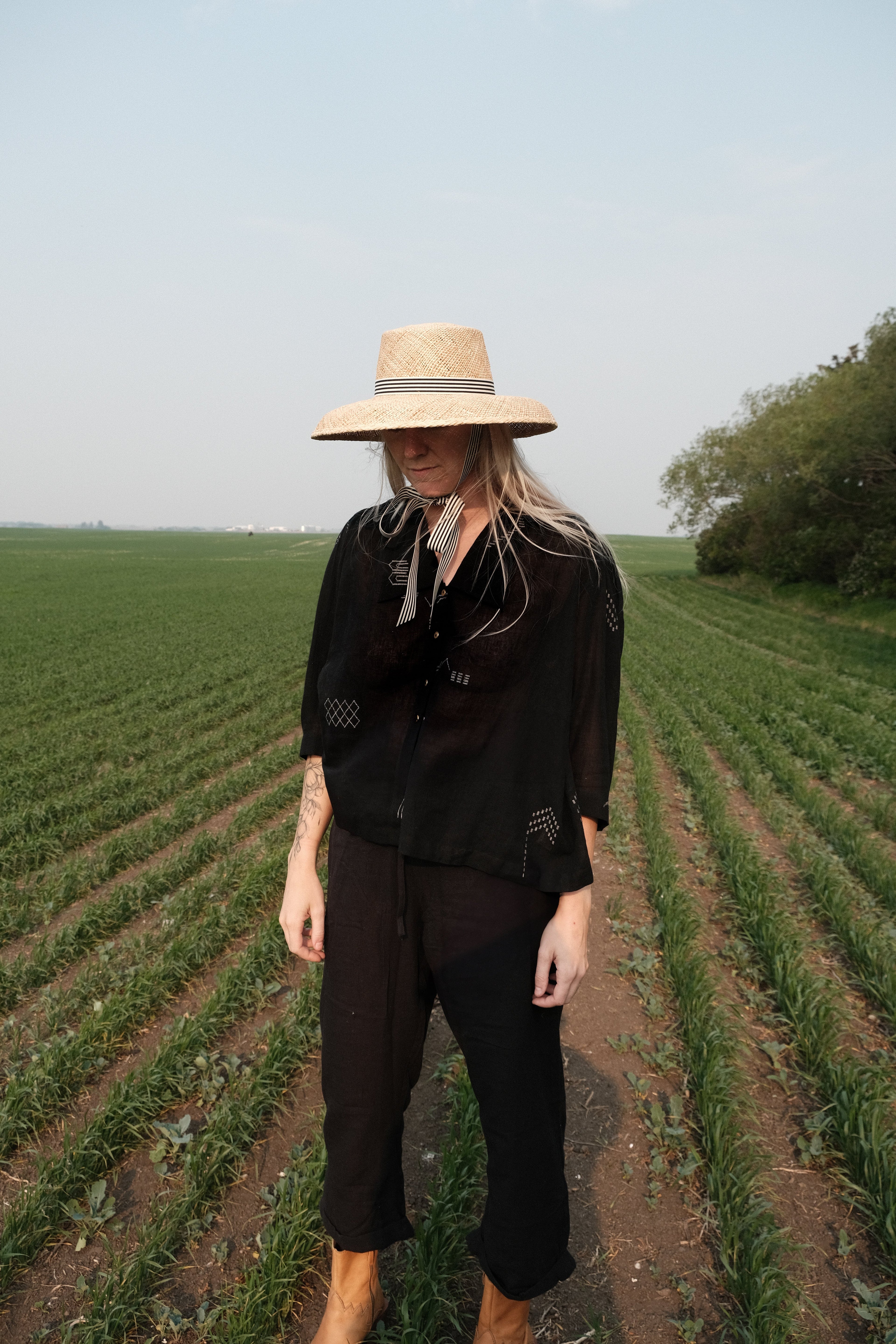 Black handwoven cotton top made from soft, lightweight fabric dyed with azo-free dyes. Ethically crafted with a breathable, non-stretchy texture that drapes effortlessly. Falls 25” from the shoulder and fits true to size, offering a relaxed yet structured silhouette. Ideal for everyday wear, this minimalist top combines timeless style with sustainable craftsmanship.