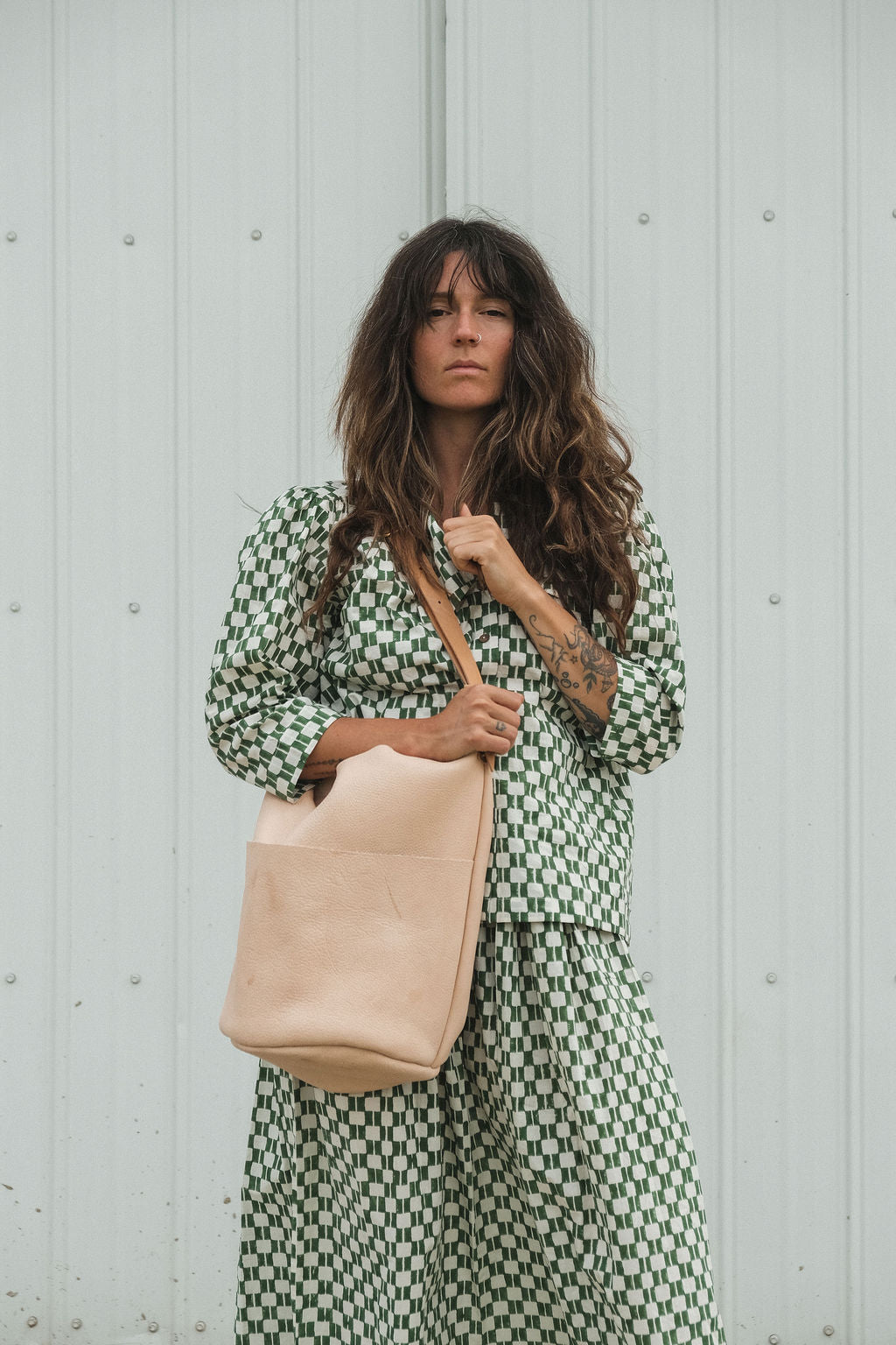 Green and white hand block-printed top made from 100% organic cotton, featuring a front button opening and a soft, breathable feel. Crafted using azo-free dyes and ethically produced, this lightweight, non-stretchy top falls 25” from the shoulder and offers a true-to-size fit. Each garment is uniquely one-of-a-kind, with natural variations in print and color that reflect its handcrafted origin—perfect for sustainable, everyday wear.
