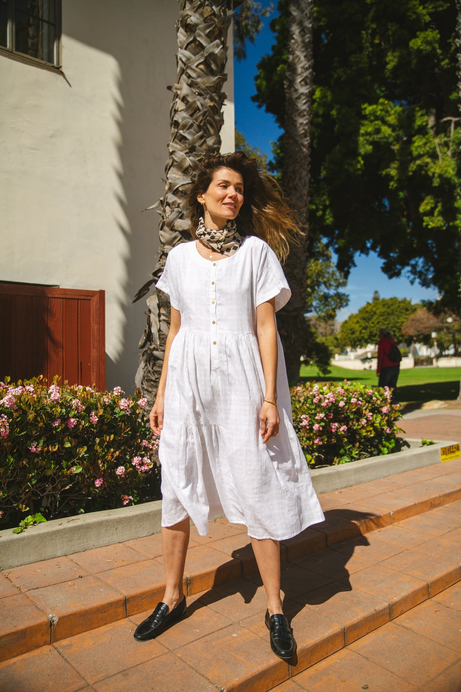 White A-line midi dress with cap sleeves, a button-down front, a gathered waist, it has delicate checks adding a texture to the garment. Made from lightweight, breathable fabric for a relaxed fit.