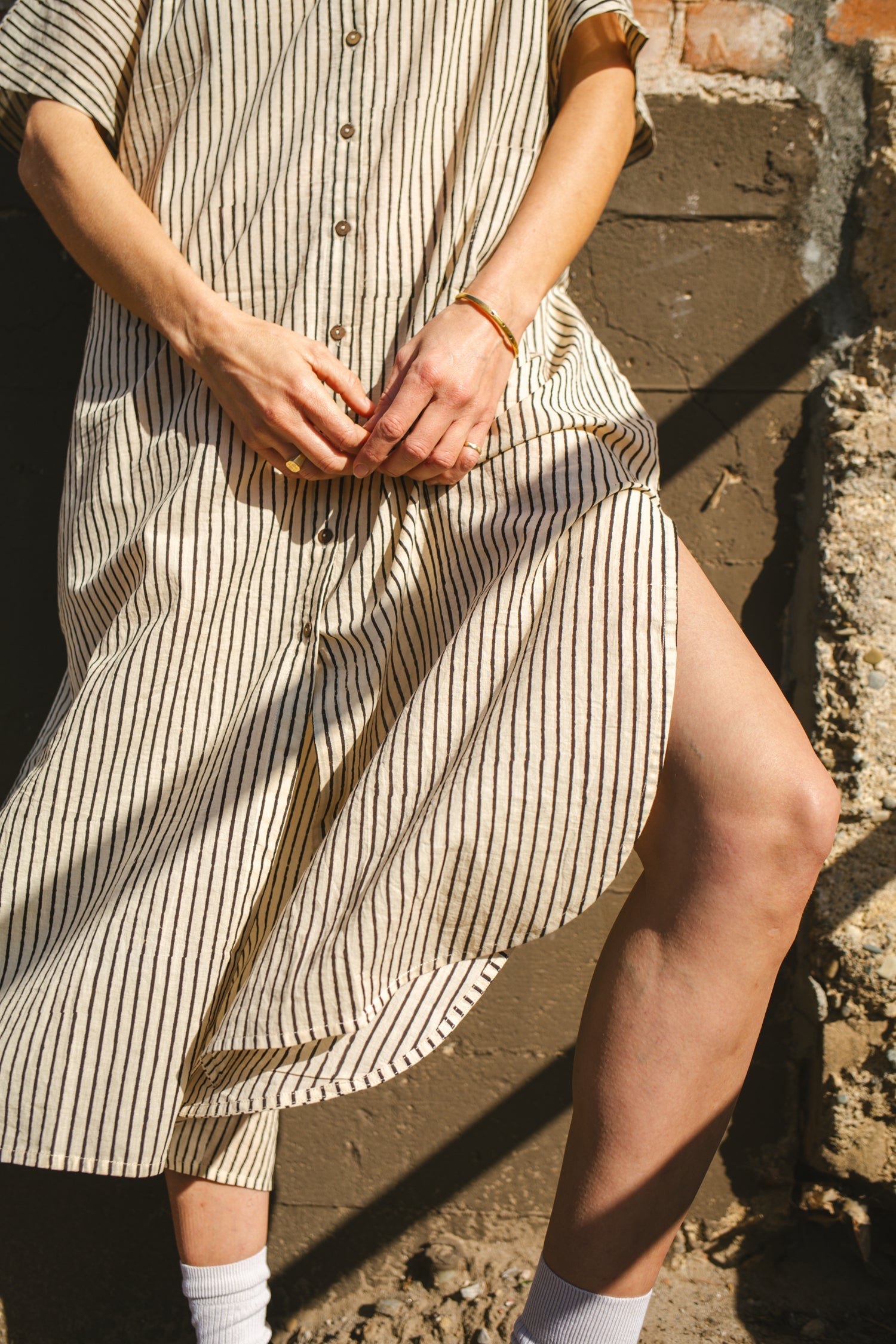 Black and white striped zebra-print shirt dress with a relaxed fit, lightweight breathable fabric, and subtle textured pattern for a stylish and comfortable look.