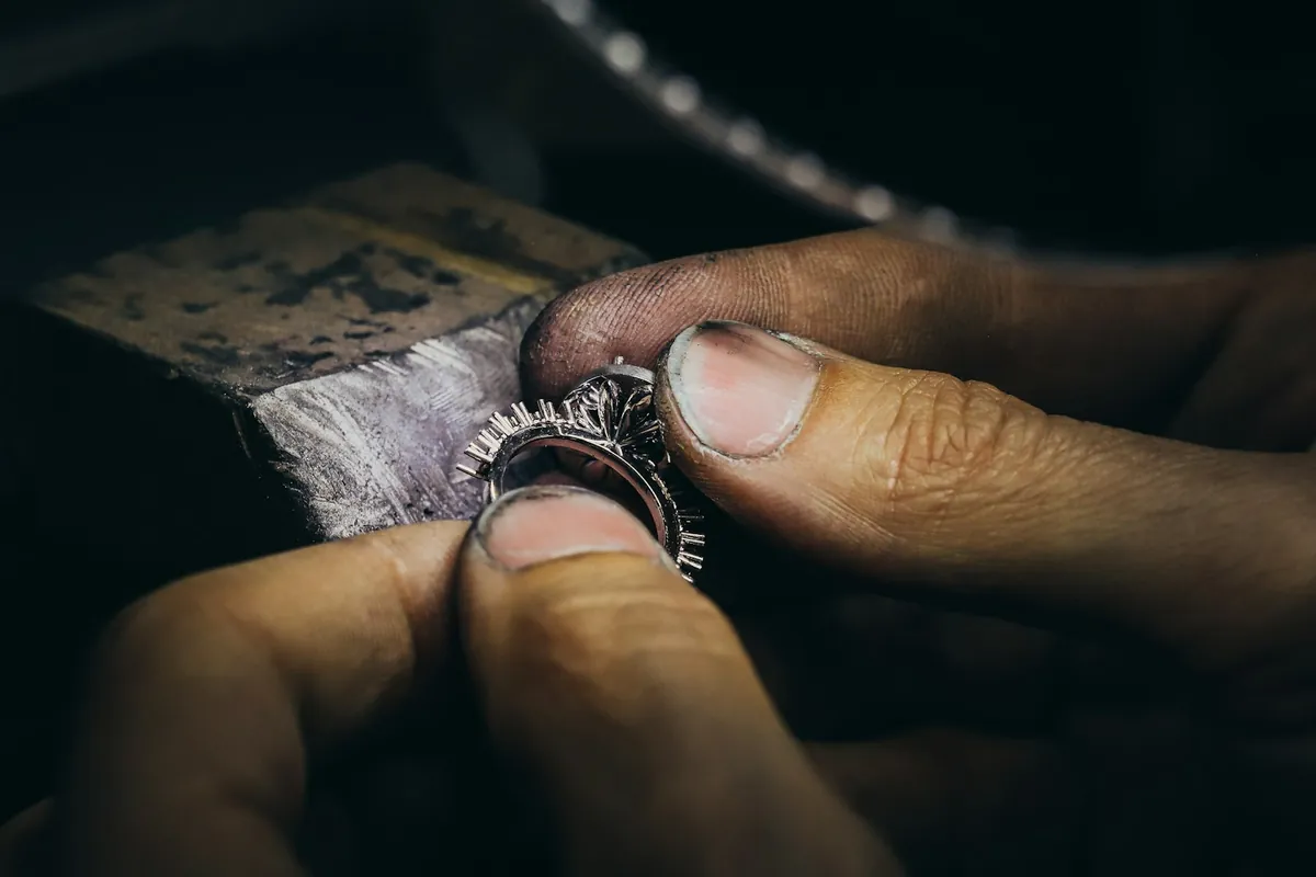 A jeweller finishing a ring by hand