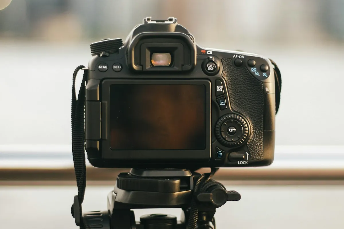 A camera on a tripod by a window