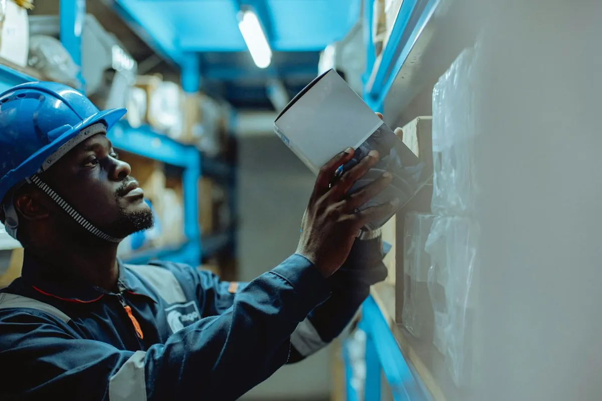 A warehouse worker checking stock with a tablet