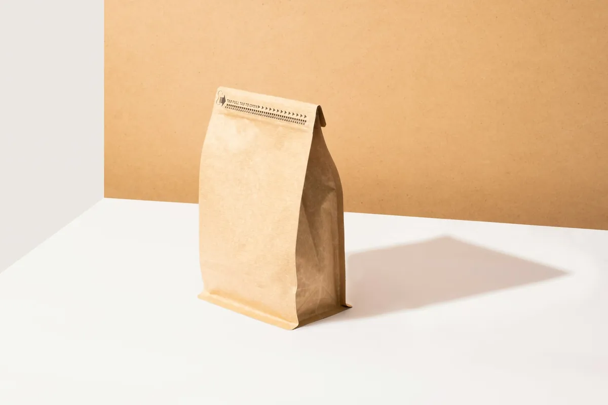 A plain kraft coffee pouch on a table