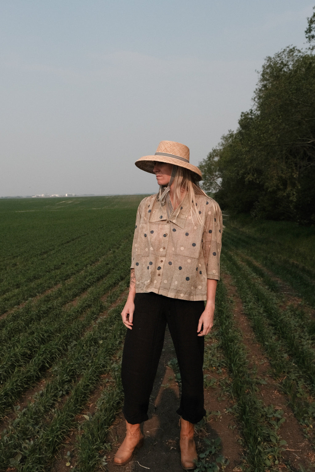 Black and tan hand block-printed top made from 100% organic cotton, featuring a front button opening and a relaxed silhouette. Naturally dyed and ethically crafted, the lightweight, non-stretchy fabric feels soft and breathable against the skin. Each piece is one-of-a-kind, with subtle variations in print and color that highlight its artisanal charm. Falls 25” from the shoulder and fits true to size—ideal for conscious, everyday wear.