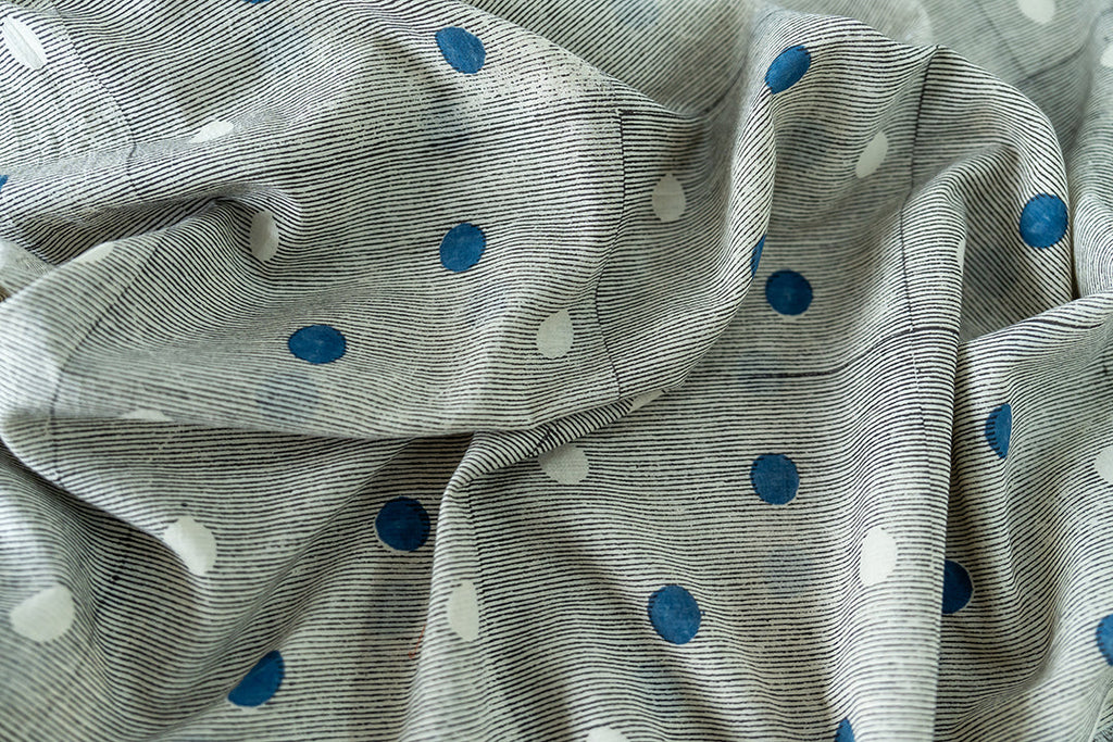 close-up of our vintage skirt - the blue & white polka dots, the black lines in the base of the fabric, giving it a charming and vintage look. 