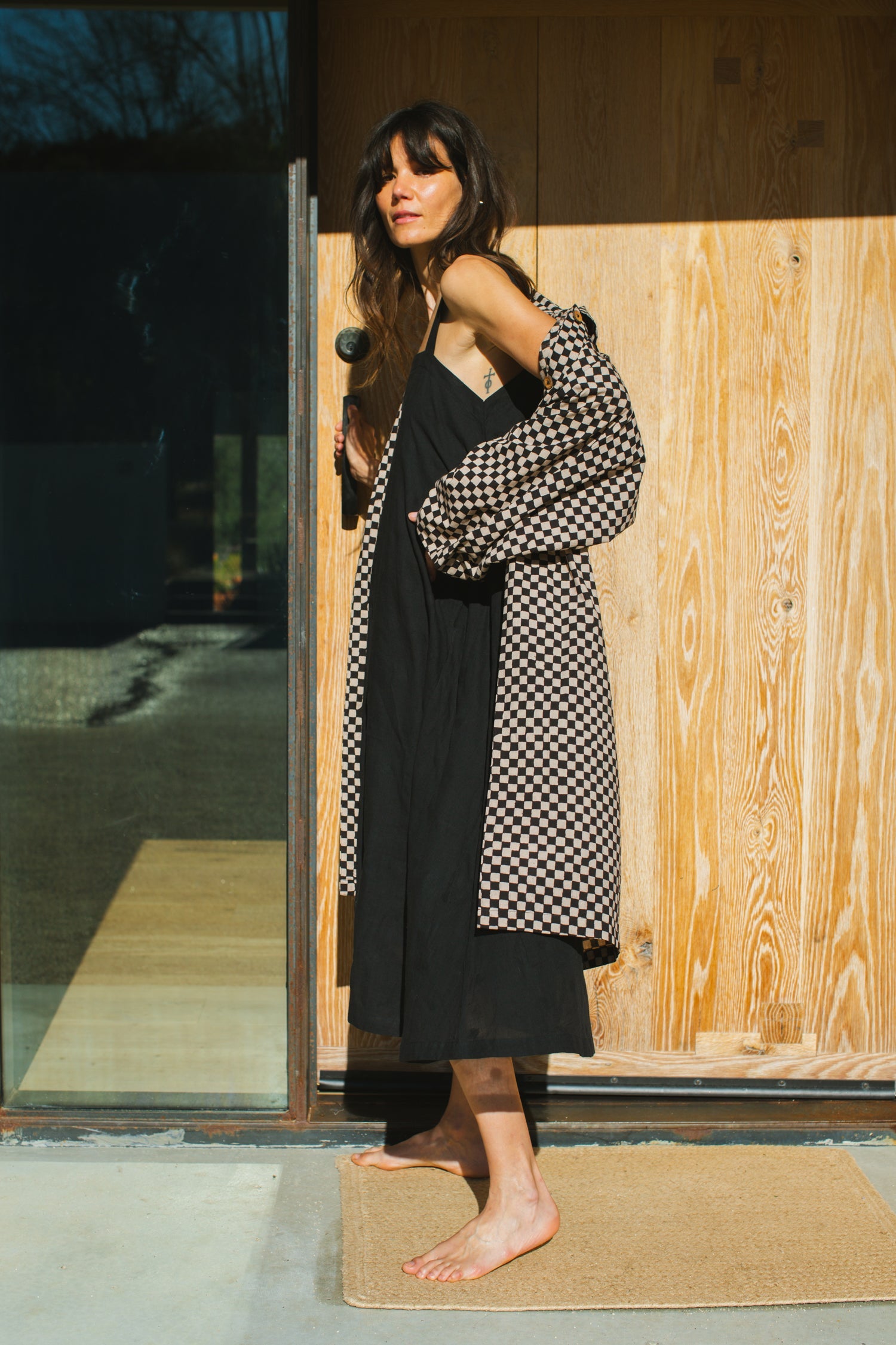 Elevate your style with this eye-catching red duster jacket, adorned with coconut buttons for a touch of natural charm. Crafted from high-quality block print fabric, this jacket boasts a timeless black and white checkered pattern, adding sophistication to any ensemble