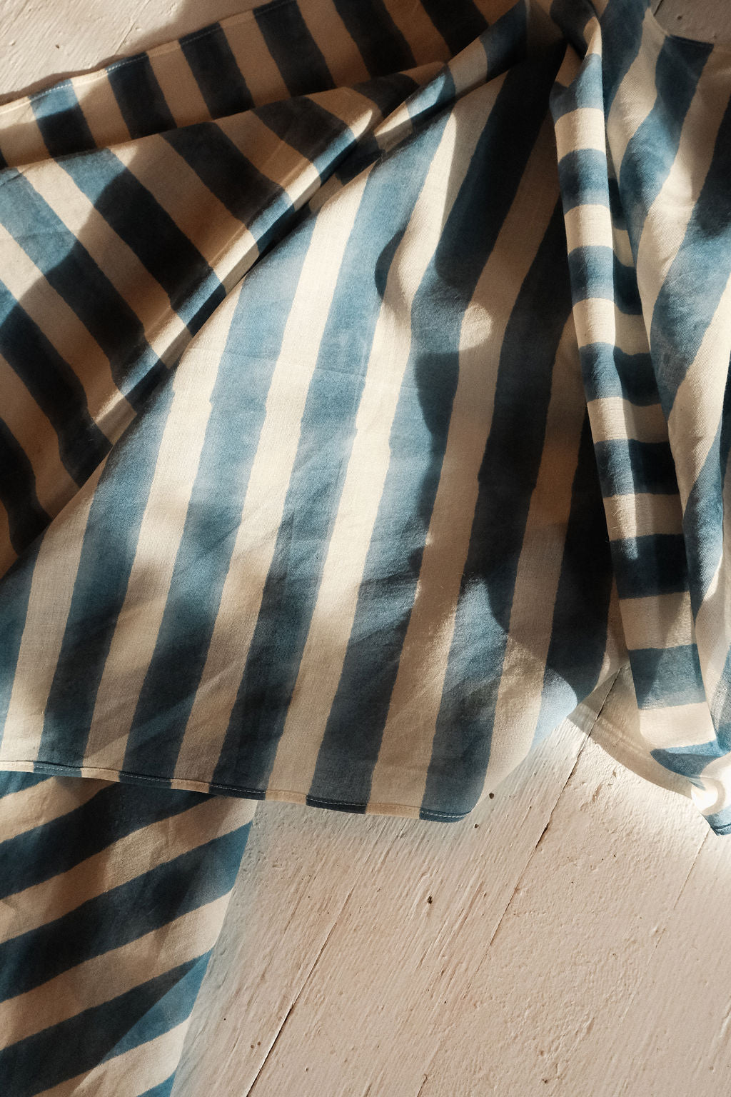 Indigo blue and white vertical striped cotton bandana by World of Crow, handwoven in India using natural dyes and traditional weaving techniques – sustainable unisex accessory for everyday wear.