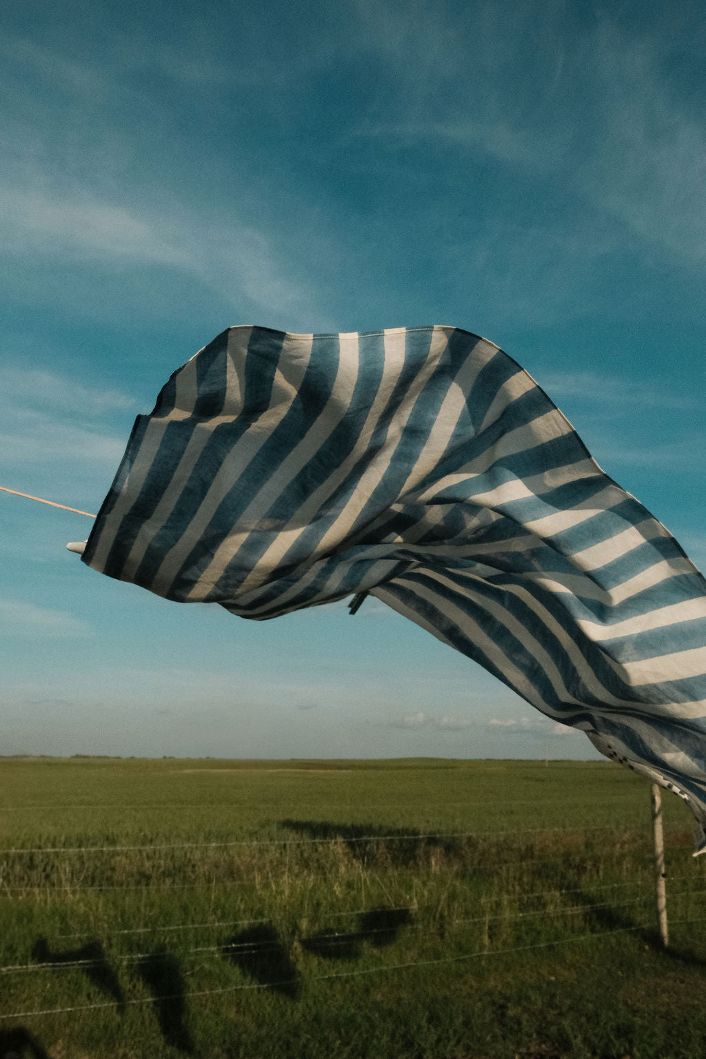 Indigo blue and white vertical striped cotton bandana by World of Crow, handwoven in India using natural dyes and traditional weaving techniques – sustainable unisex accessory for everyday wear.
