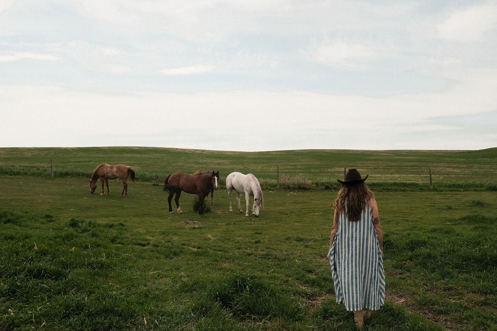 Sleeveless blue & white striped, hand woven cotton dress. The A-line silhouette and midi length at the charm to the dress. It has a V-neck adding the feminine touch to the bespoke piece. 