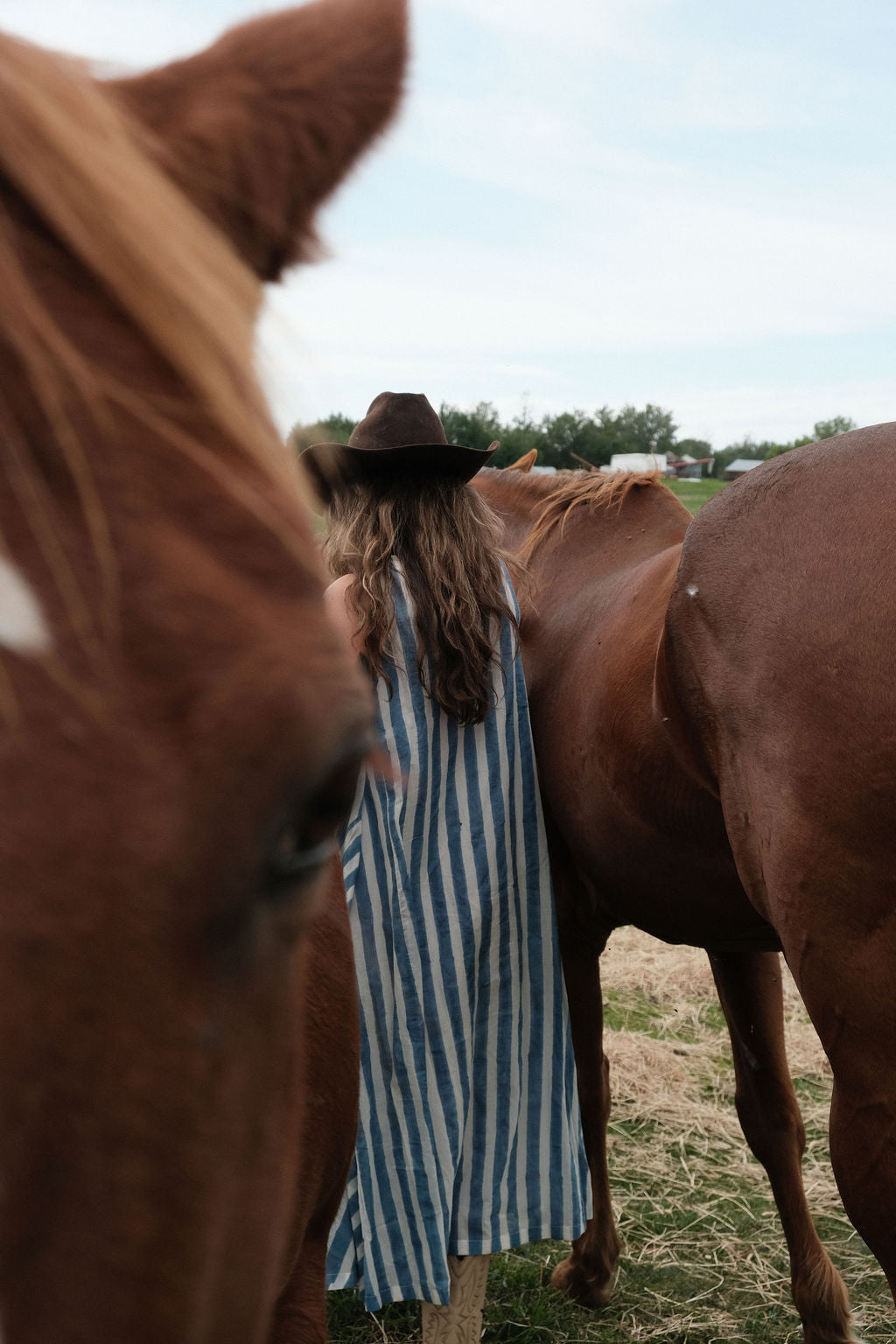 Sleeveless blue & white striped, hand woven cotton dress. The A-line silhouette and midi length at the charm to the dress. It has a V-neck adding the feminine touch to the bespoke piece. 