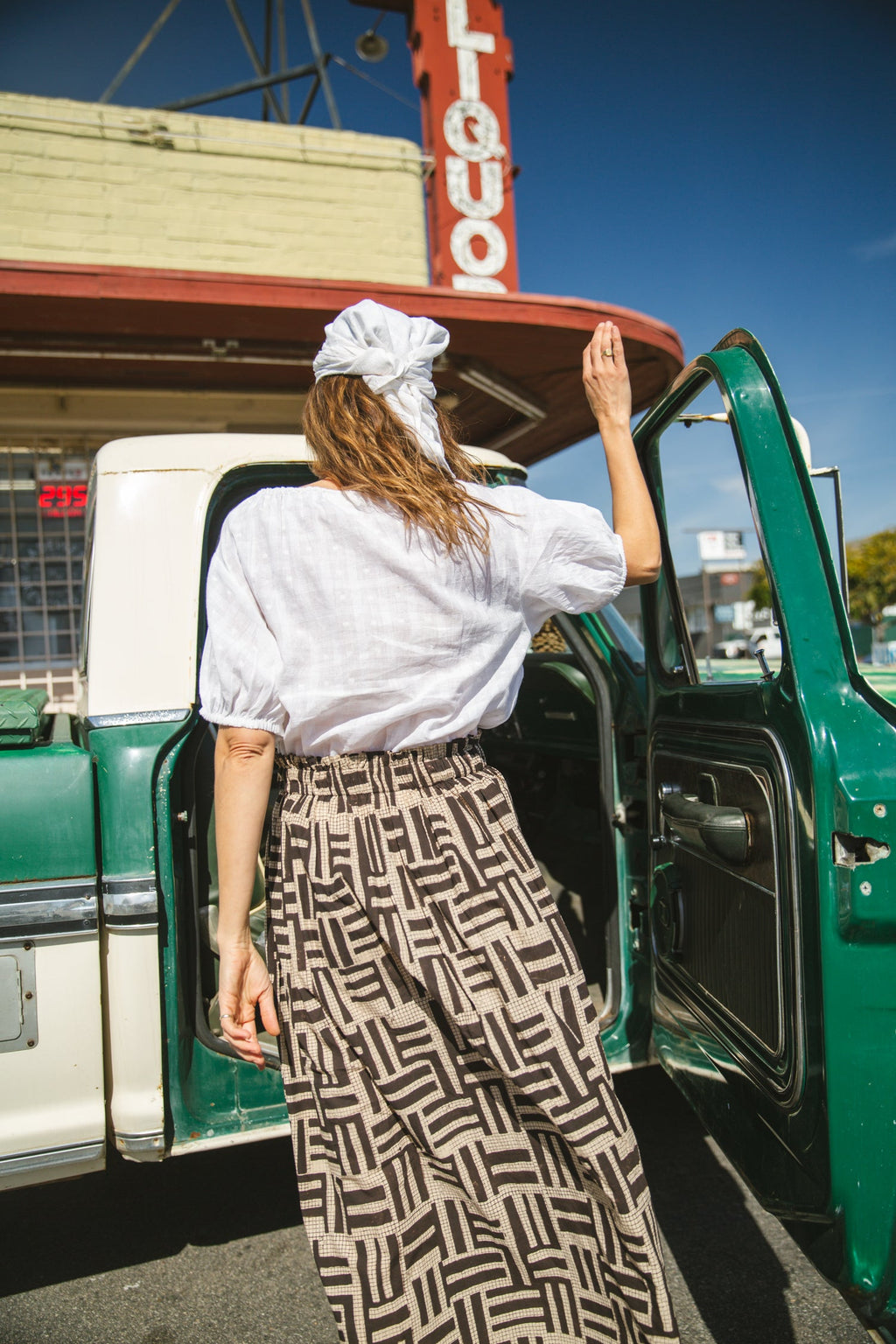 High-waisted, full-length skirt with a gathered waist and an abstract geometric print in black and beige. The voluminous silhouette and structured pleats add movement and a vintage-inspired charm, making it a statement piece with a bohemian flair.