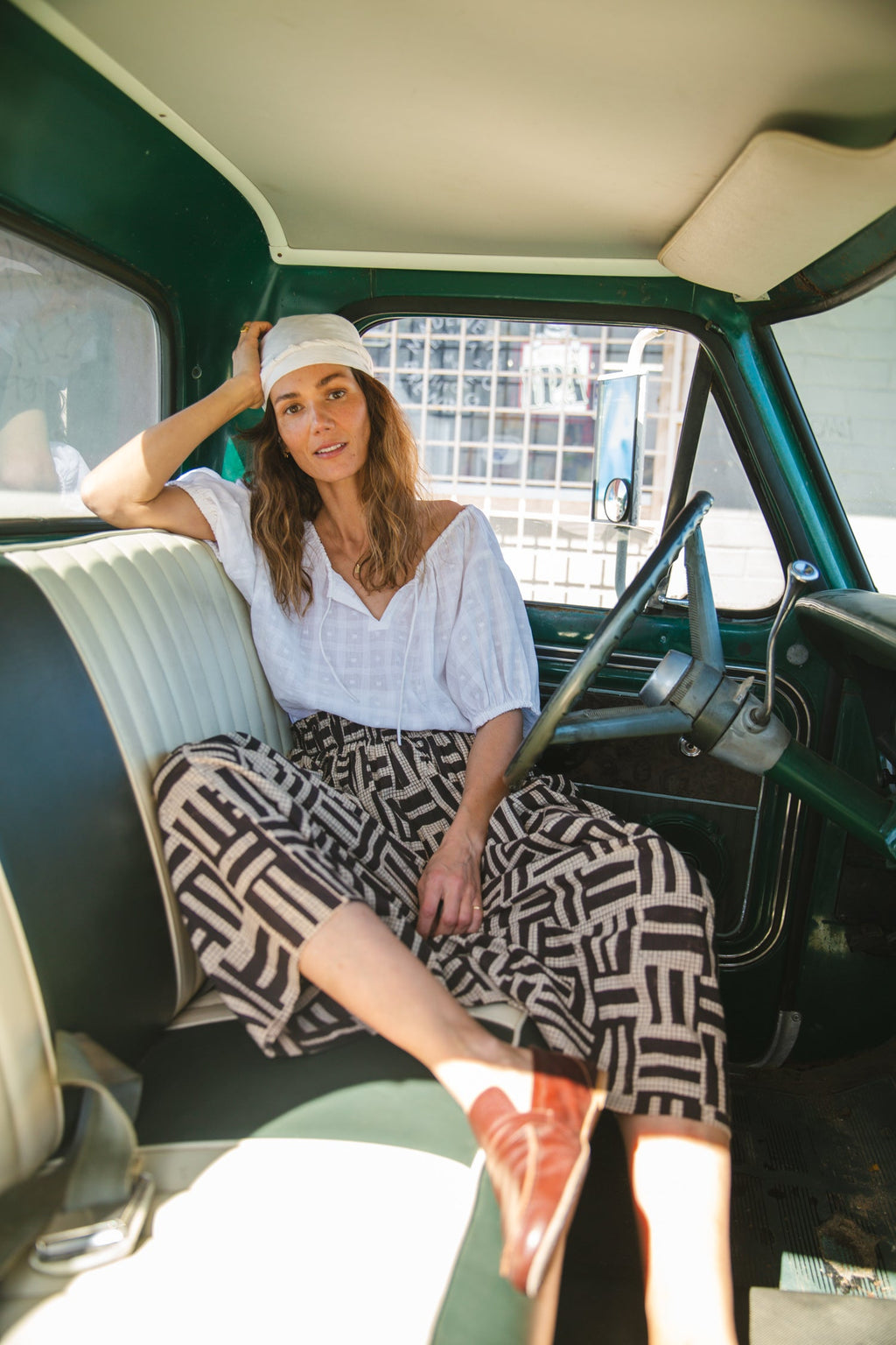 High-waisted, full-length skirt with a gathered waist and an abstract geometric print in black and beige. The voluminous silhouette and structured pleats add movement and a vintage-inspired charm, making it a statement piece with a bohemian flair.