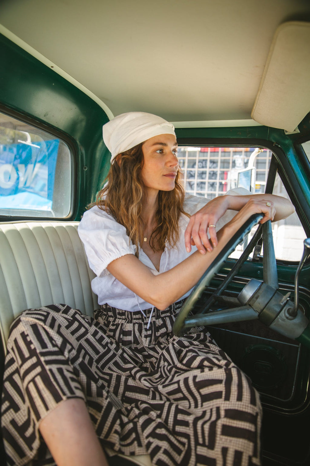High-waisted, full-length skirt with a gathered waist and an abstract geometric print in black and beige. The voluminous silhouette and structured pleats add movement and a vintage-inspired charm, making it a statement piece with a bohemian flair.