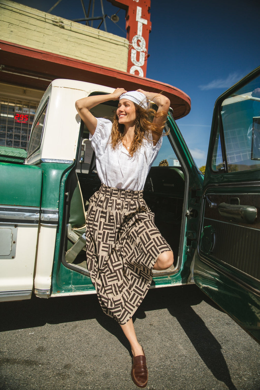 High-waisted, full-length skirt with a gathered waist and an abstract geometric print in black and beige. The voluminous silhouette and structured pleats add movement and a vintage-inspired charm, making it a statement piece with a bohemian flair.