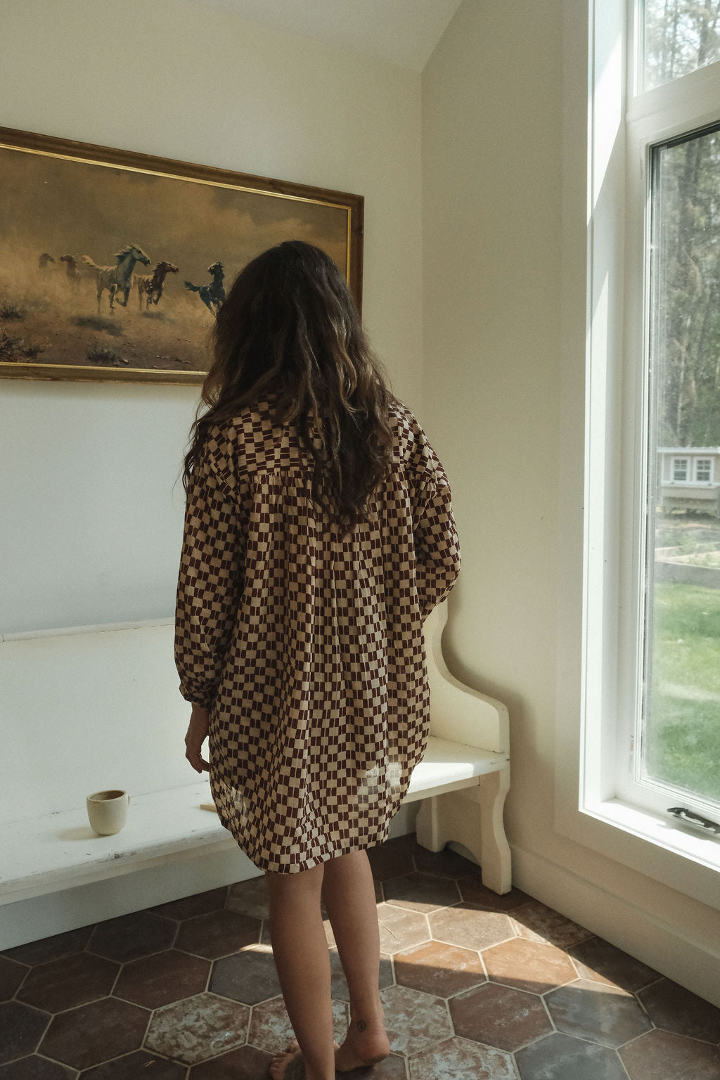 Artist smock crafted from soft, organic cotton, adorned with a hand block-printed design that carries the charm of artisanal craftsmanship. Dyed using gentle, azo-free pigments, the fabric breathes naturally and feels effortless on the skin. Featuring a front button closure and a clean, straight collar, this piece blends tradition with a modern, minimalist silhouette—perfect for thoughtful, everyday dressing. Each smock is one-of-a-kind, echoing the quiet beauty of slow-made fashion.