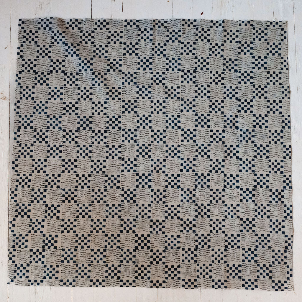 Navy blue and white handwoven checkered cotton bandana by World of Crow, ethically made in India using traditional weaving techniques – sustainable slow fashion accessory for versatile styling.