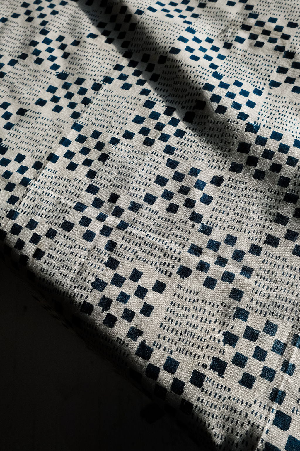 Navy blue and white handwoven checkered cotton bandana by World of Crow, ethically made in India using traditional weaving techniques – sustainable slow fashion accessory for versatile styling.