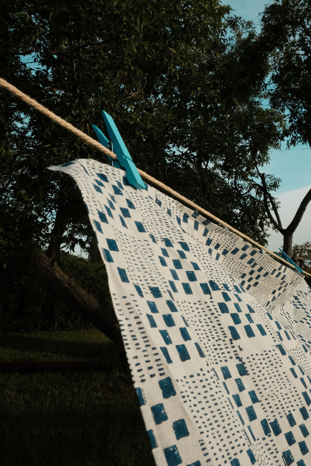 Navy blue and white handwoven checkered cotton bandana by World of Crow, ethically made in India using traditional weaving techniques – sustainable slow fashion accessory for versatile styling.