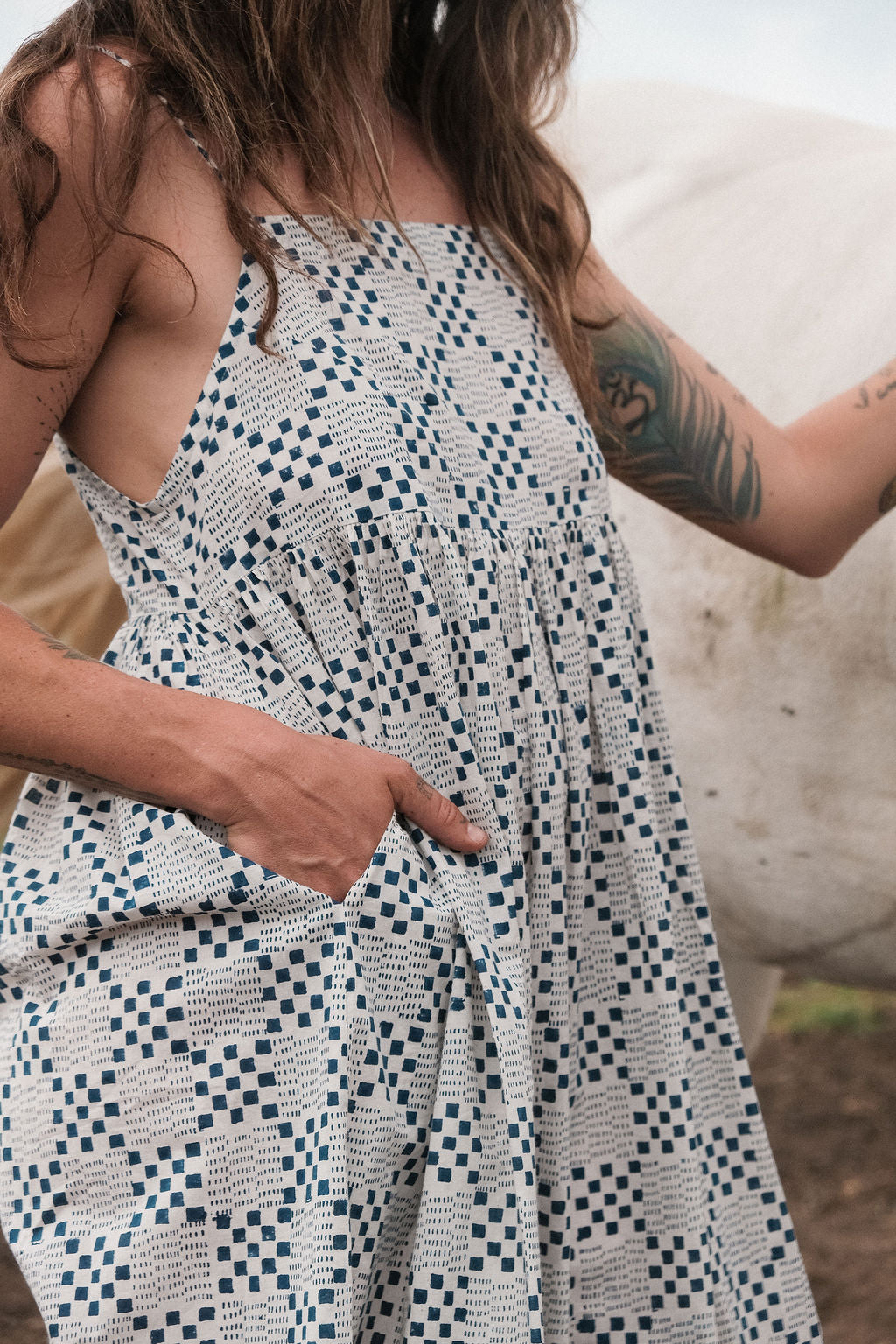 White and indigo blue hand block-printed dress made from 100% organic cotton, crafted with azo-free dyes for a soft and breathable feel. Ethically made with a lightweight, non-stretchy fabric, the dress falls 45” from the shoulder in size S and offers a true-to-size fit. Each garment is uniquely one-of-a-kind, with natural variations in color and pattern that highlight its handcrafted charm—perfect for conscious, everyday dressing.