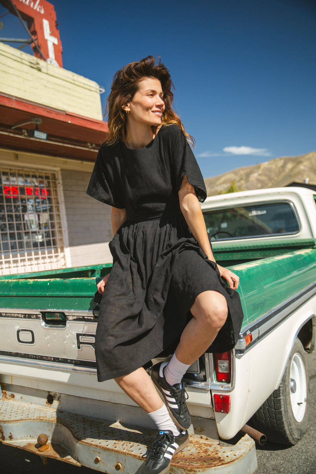 Black jamdani fabric dress with a soft, breathable texture, featuring a fitted bodice, cinched waist, and a flowy midi skirt for an effortlessly elegant and timeless silhouette.