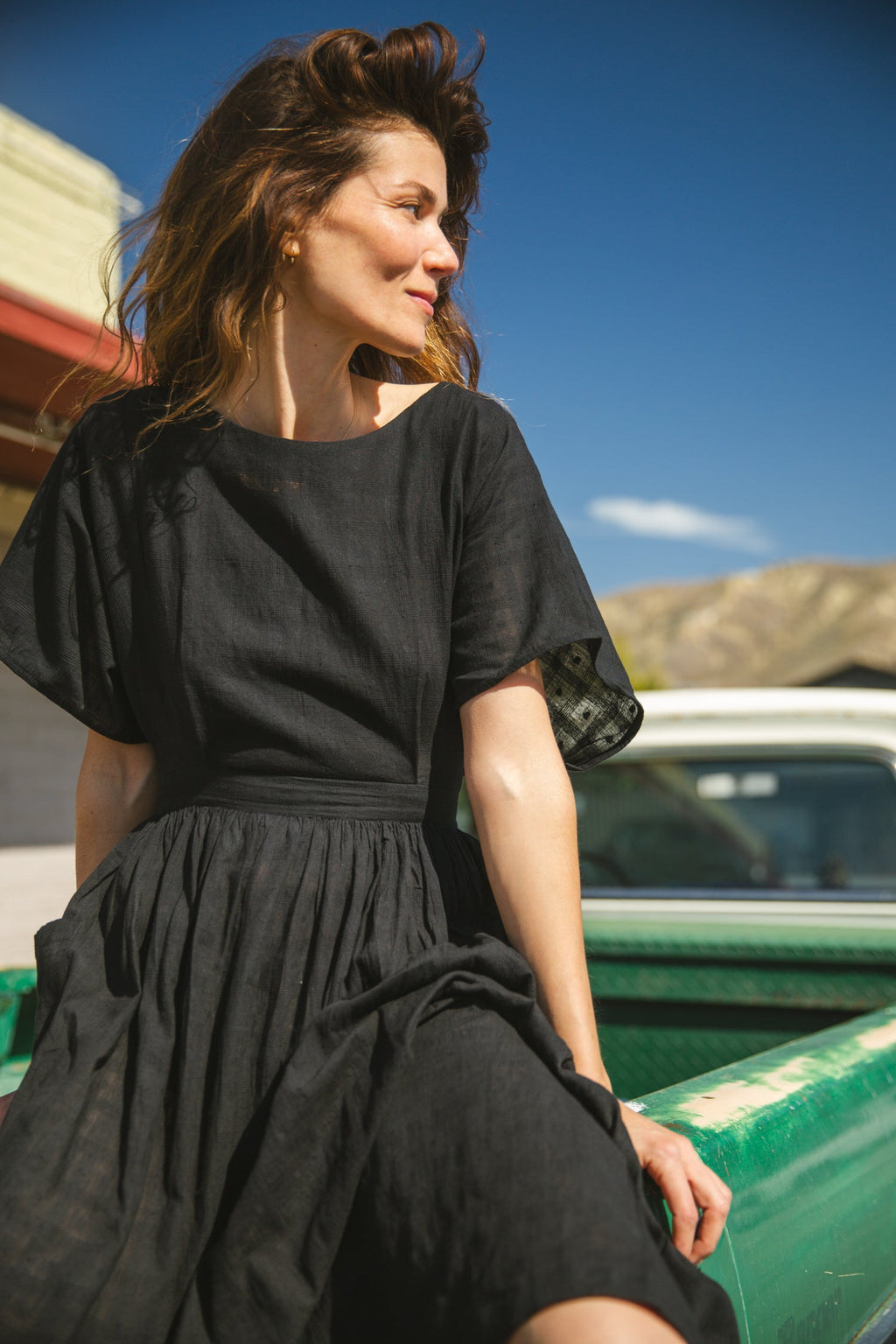 Black jamdani fabric dress with a soft, breathable texture, featuring a fitted bodice, cinched waist, and a flowy midi skirt for an effortlessly elegant and timeless silhouette.