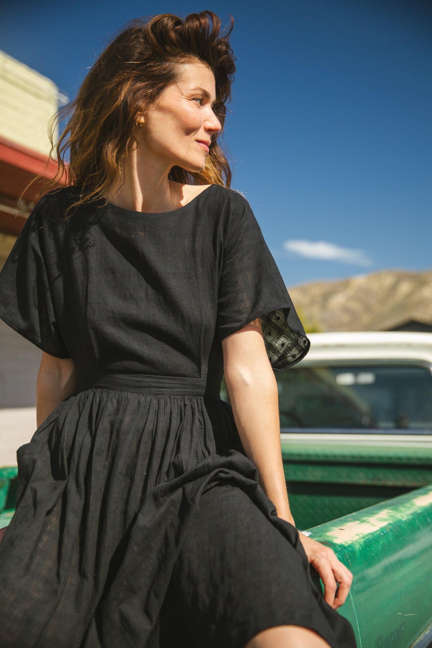 Black jamdani fabric dress with a soft, breathable texture, featuring a fitted bodice, cinched waist, and a flowy midi skirt for an effortlessly elegant and timeless silhouette.