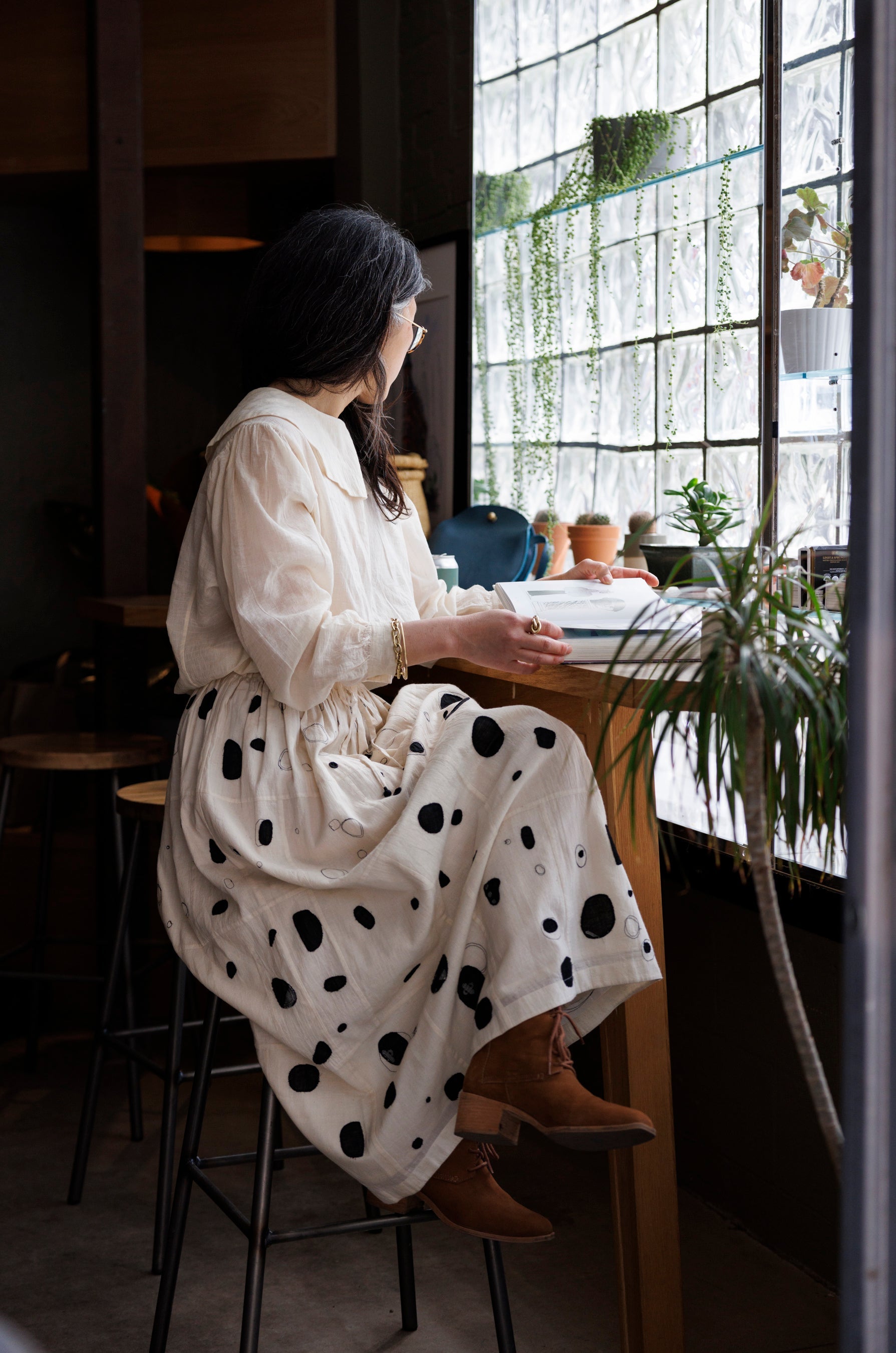 This Raindrops skirt is meticulously crafted from hand-woven fabric. Its exquisite appliqué work adds a touch of enchantment, elevating any ensemble. With its timeless black and white palette, this skirt effortlessly complements a variety of tops and shirts, ensuring versatility and sophistication with every wear.