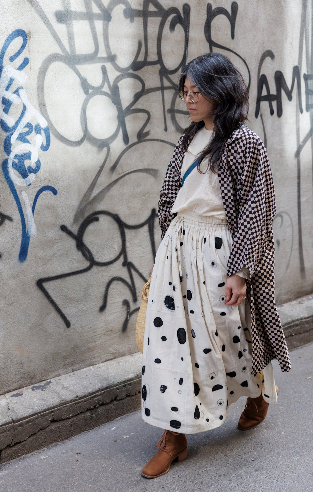 Elevate your style with this eye-catching red duster jacket, adorned with coconut buttons for a touch of natural charm. Crafted from high-quality block print fabric, this jacket boasts a timeless black and white checkered pattern, adding sophistication to any ensemble