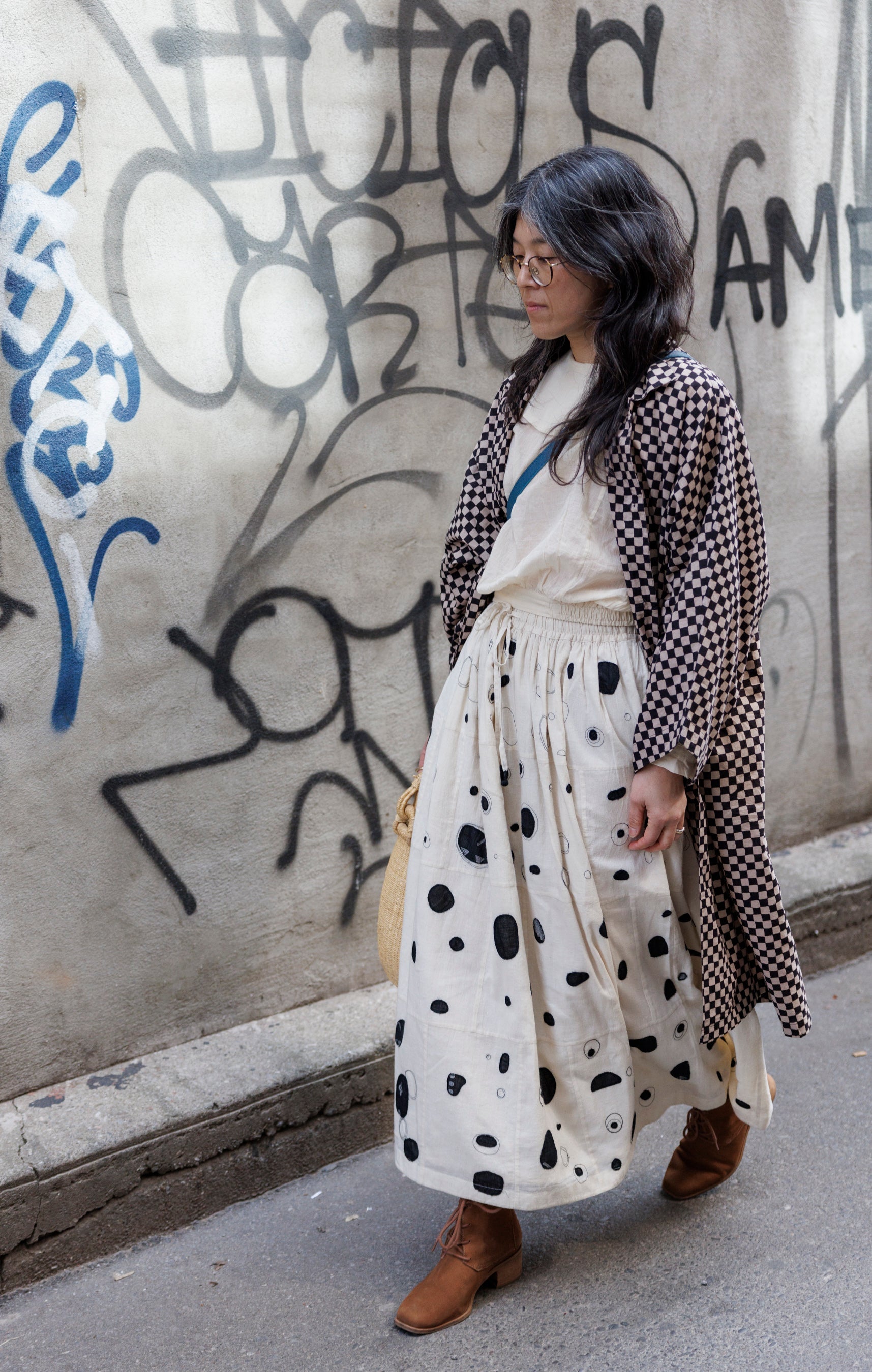 Elevate your style with this eye-catching red duster jacket, adorned with coconut buttons for a touch of natural charm. Crafted from high-quality block print fabric, this jacket boasts a timeless black and white checkered pattern, adding sophistication to any ensemble