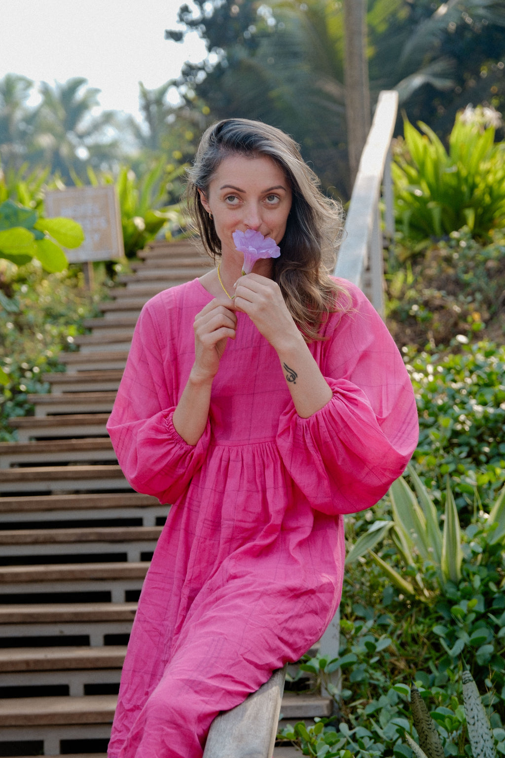 This Get Away Dress is made in a collaboration between Erica Kim @ahistoryofarchitecture and World of Crow, the dress has a scoop neck, barbie pink color, light checks in jamdani fabric