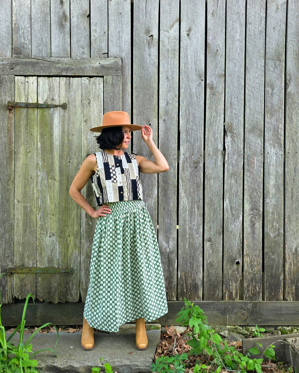 Green and white hand block-printed skirt made from 100% organic cotton, featuring a soft, lightweight fabric with azo-free dyes. Designed with a comfortable elasticated waist, full lining, and side pockets, this ethically made skirt falls 36” from the waist and fits true to size with a relaxed drape over the hips and legs. Each piece is uniquely handcrafted, with natural variations in color and pattern that reflect its artisanal charm—ideal for effortless, everyday wear.