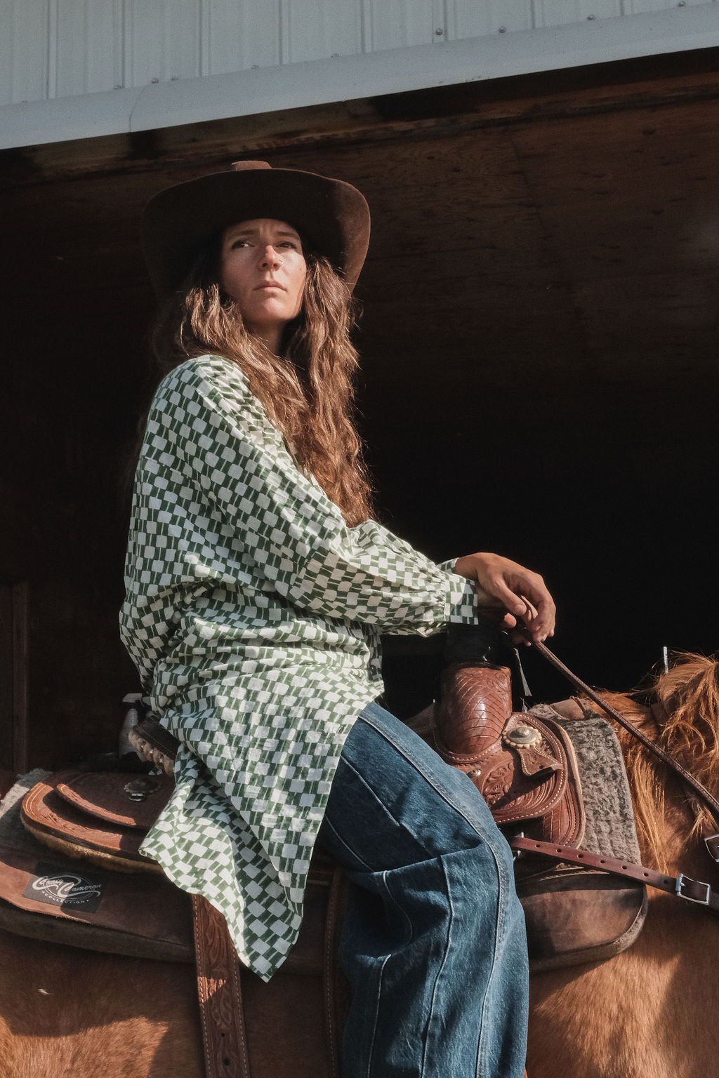 Green and white hand block-printed dress made from 100% organic cotton, featuring a front button opening and high-low hemline. Crafted over 5 days using azo-free dyes, the lightweight, non-stretchy fabric feels soft and breathable on the skin. Each piece is ethically made and uniquely one-of-a-kind, with subtle variations in print and color that highlight its artisanal nature. Falls 42” from the shoulder, offering a relaxed silhouette that fits true to size.