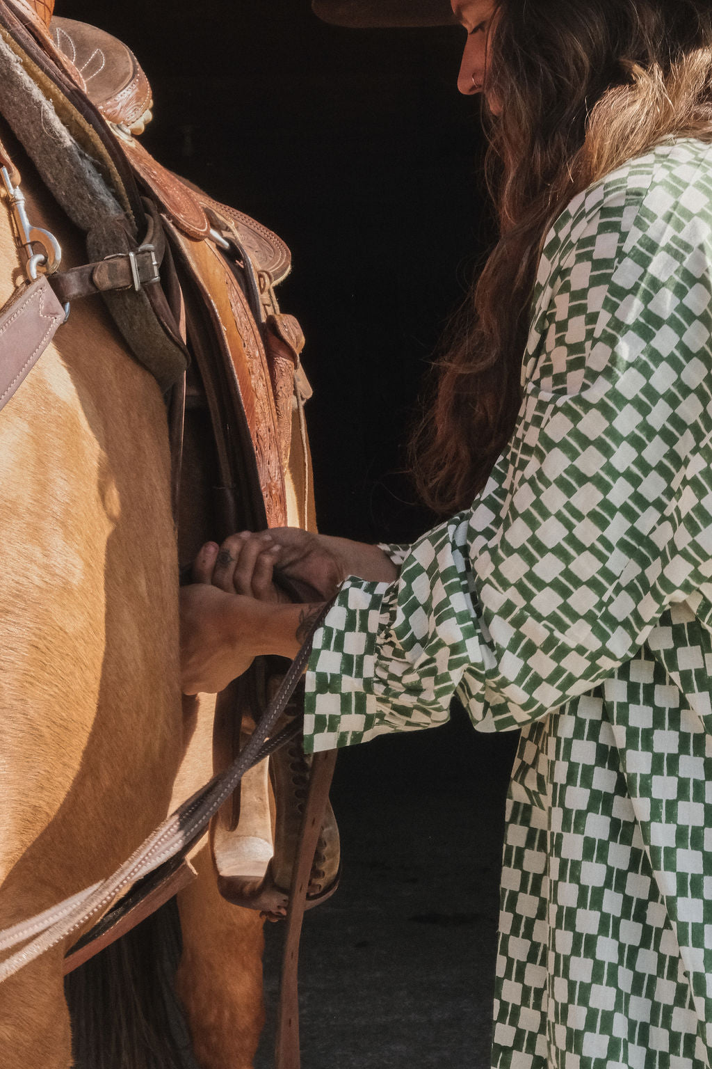 Green and white hand block-printed dress made from 100% organic cotton, featuring a front button opening and high-low hemline. Crafted over 5 days using azo-free dyes, the lightweight, non-stretchy fabric feels soft and breathable on the skin. Each piece is ethically made and uniquely one-of-a-kind, with subtle variations in print and color that highlight its artisanal nature. Falls 42” from the shoulder, offering a relaxed silhouette that fits true to size.